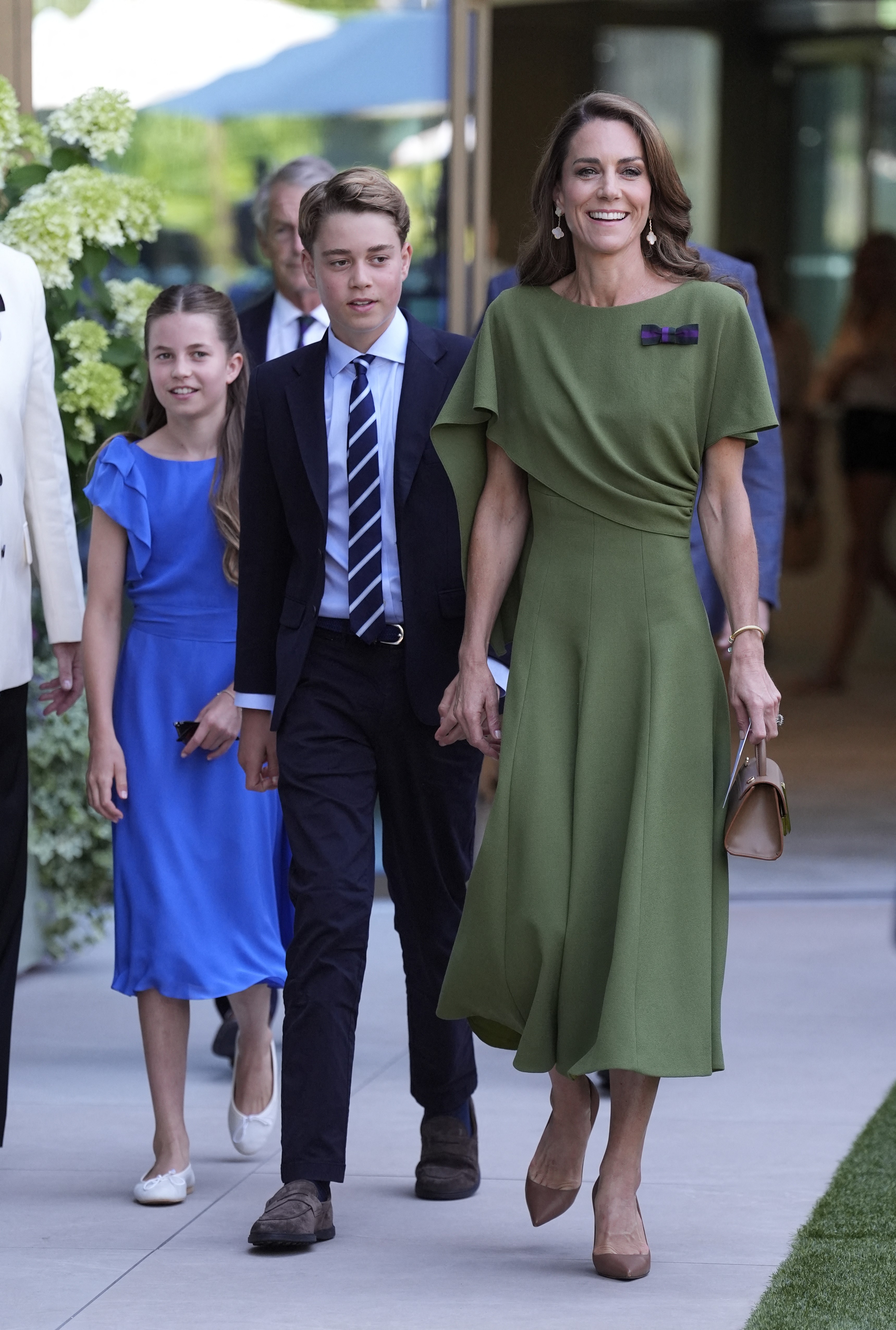 Princess Charlotte stole the spotlight from her mother wearing one of her most favored colors. In this photo, she, Catherine, Princess of Wales, and Prince George of Wales arrived to attend the men's singles final tennis match. | Source: Getty Images