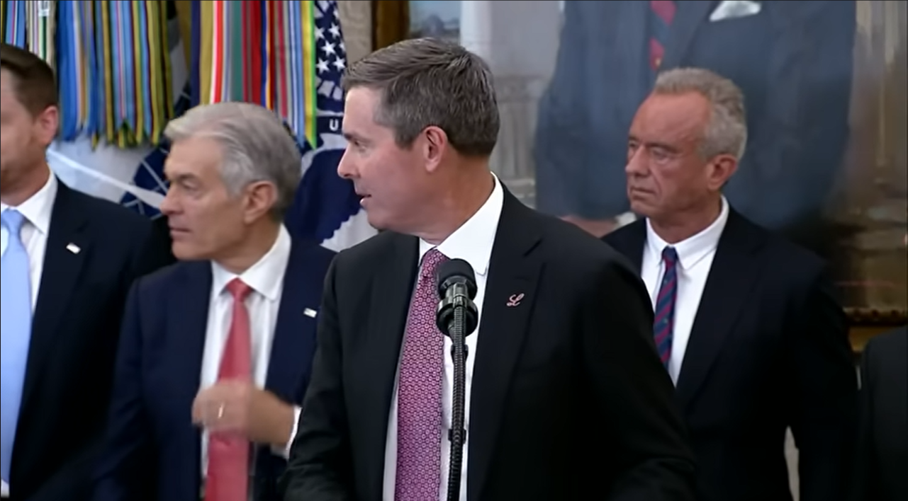 Eli Lilly CEO, David Ricks, turns as Gordon Findlay begins to collapse during the Oval Office event on November 6, 2025 | Source: YouTube/@fox5dc