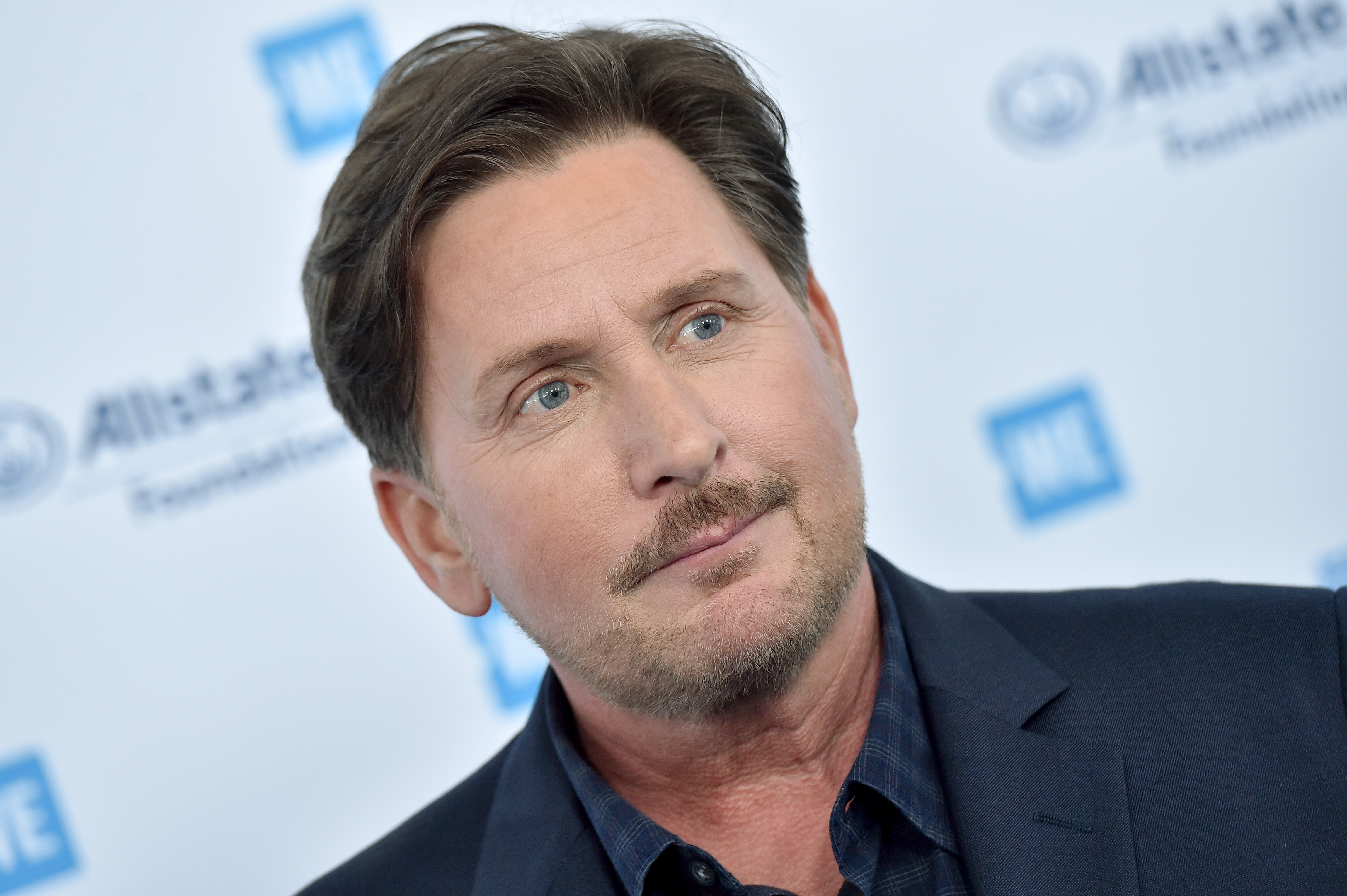 Emilio Estevez poses for photographers at an event. | Source: Getty Images