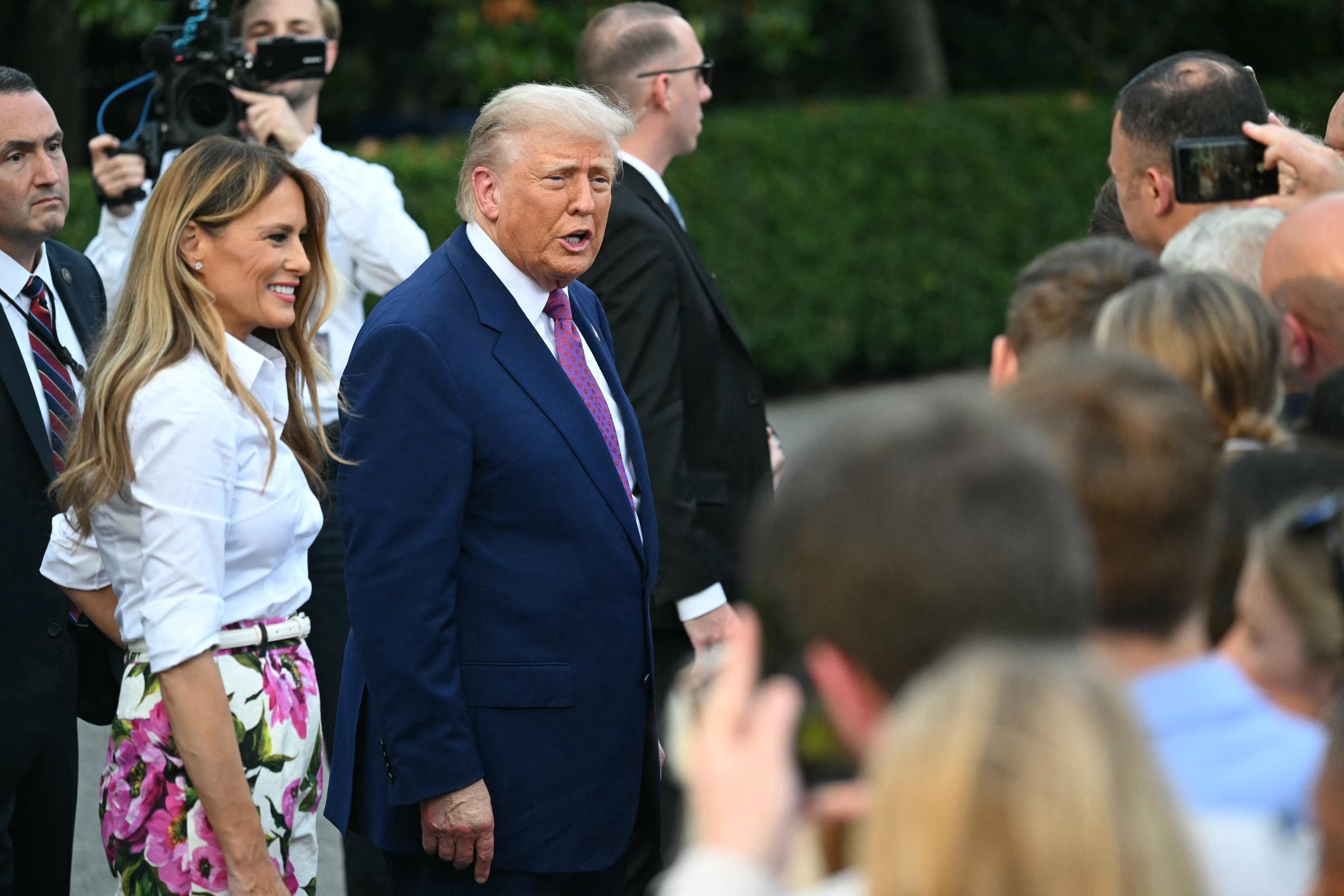 Donald and Melania Trump greet attendees as they arrive at the Congressional Picnic on the South Lawn of the White House on June 12, 2025 in Washington, DC | Source: Getty Images