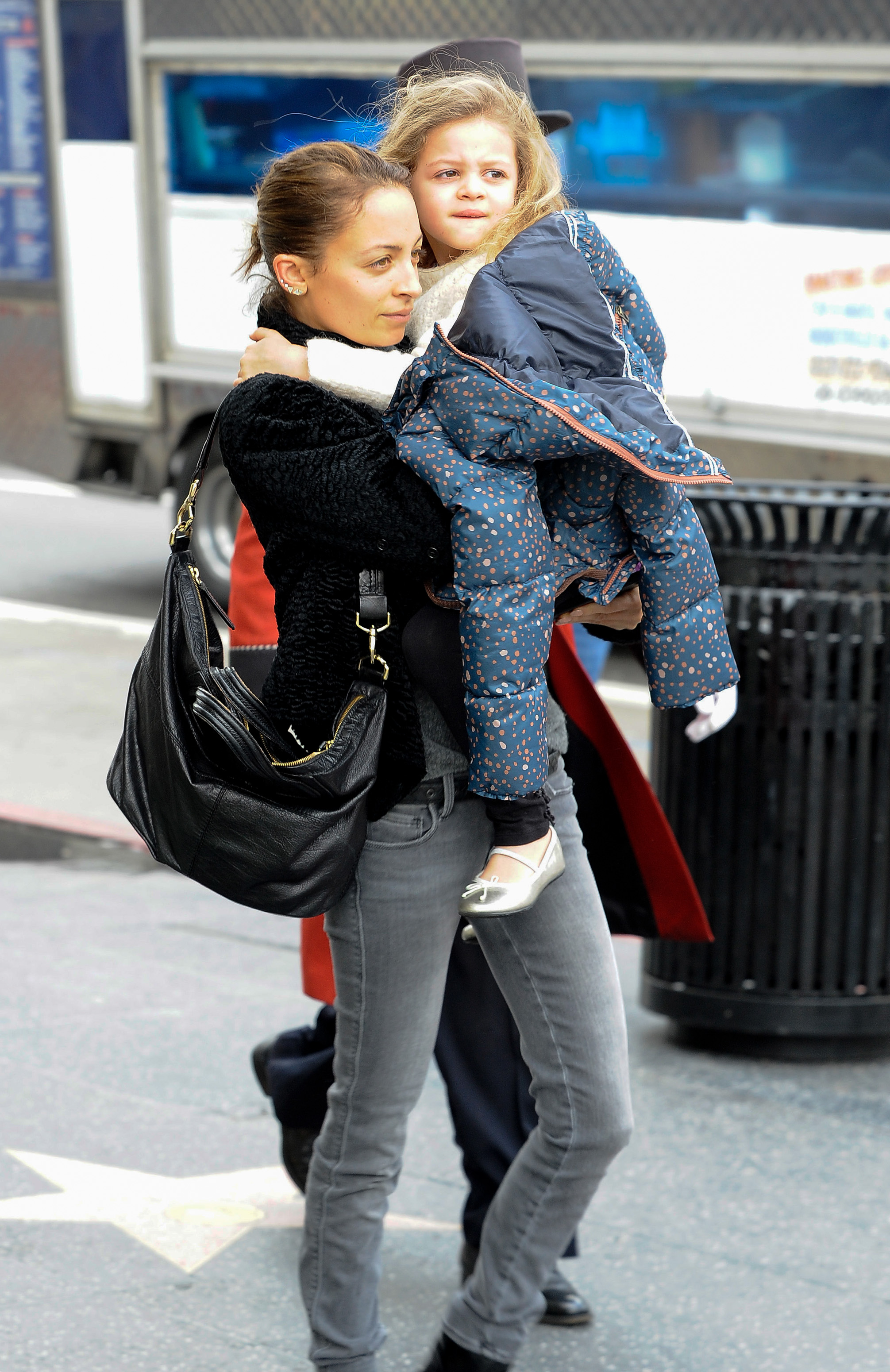 Nicole Richie carries Harlow Winter Kate Madden through Los Angeles in February 2014. Wrapped in a dark printed coat, Kate gazes ahead while Nicole keeps her close during the city outing.