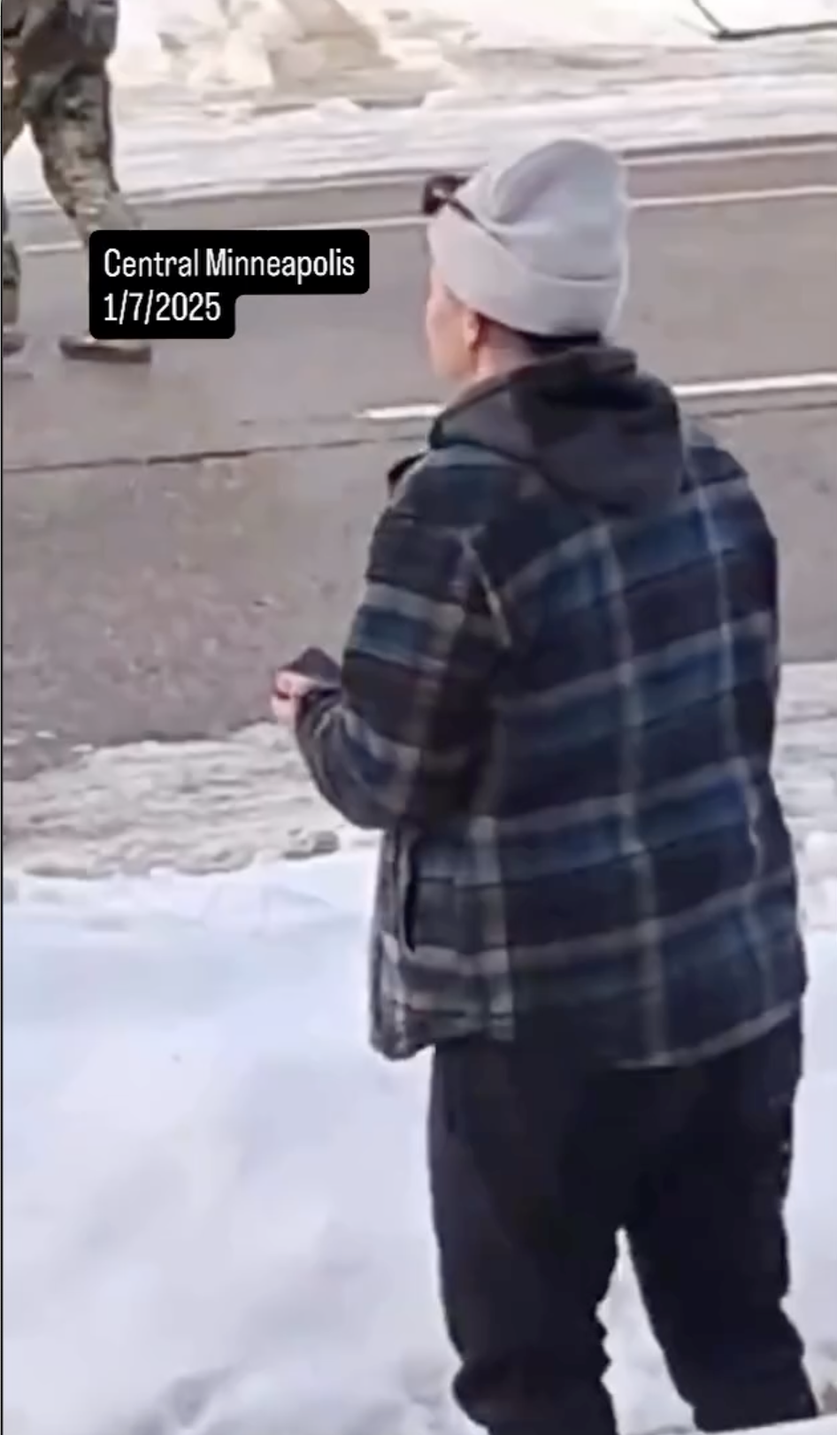 Renee Nicole Good's alleged wife standing near the car crash site after she was shot by an ICE agent on January 7, 2026 | Source: Instagram/migrantinsider