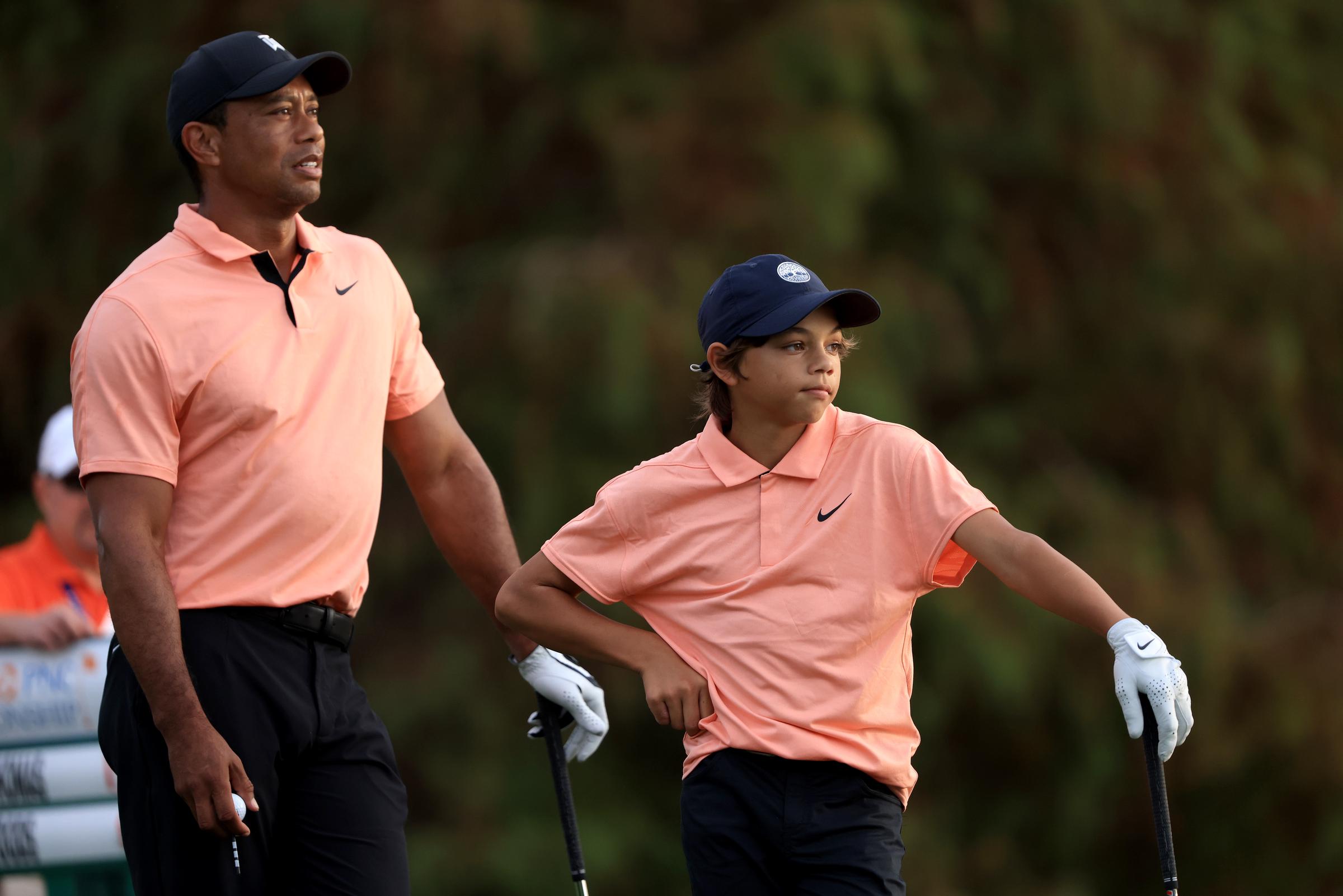 Tiger Woods and Charlie Woods wait to play on the 17th hole during the first round of the PNC Championship at the Ritz-Carlton Golf Club Grande Lakes on December 18, 2021, in Orlando, Florida | Source: Getty Images