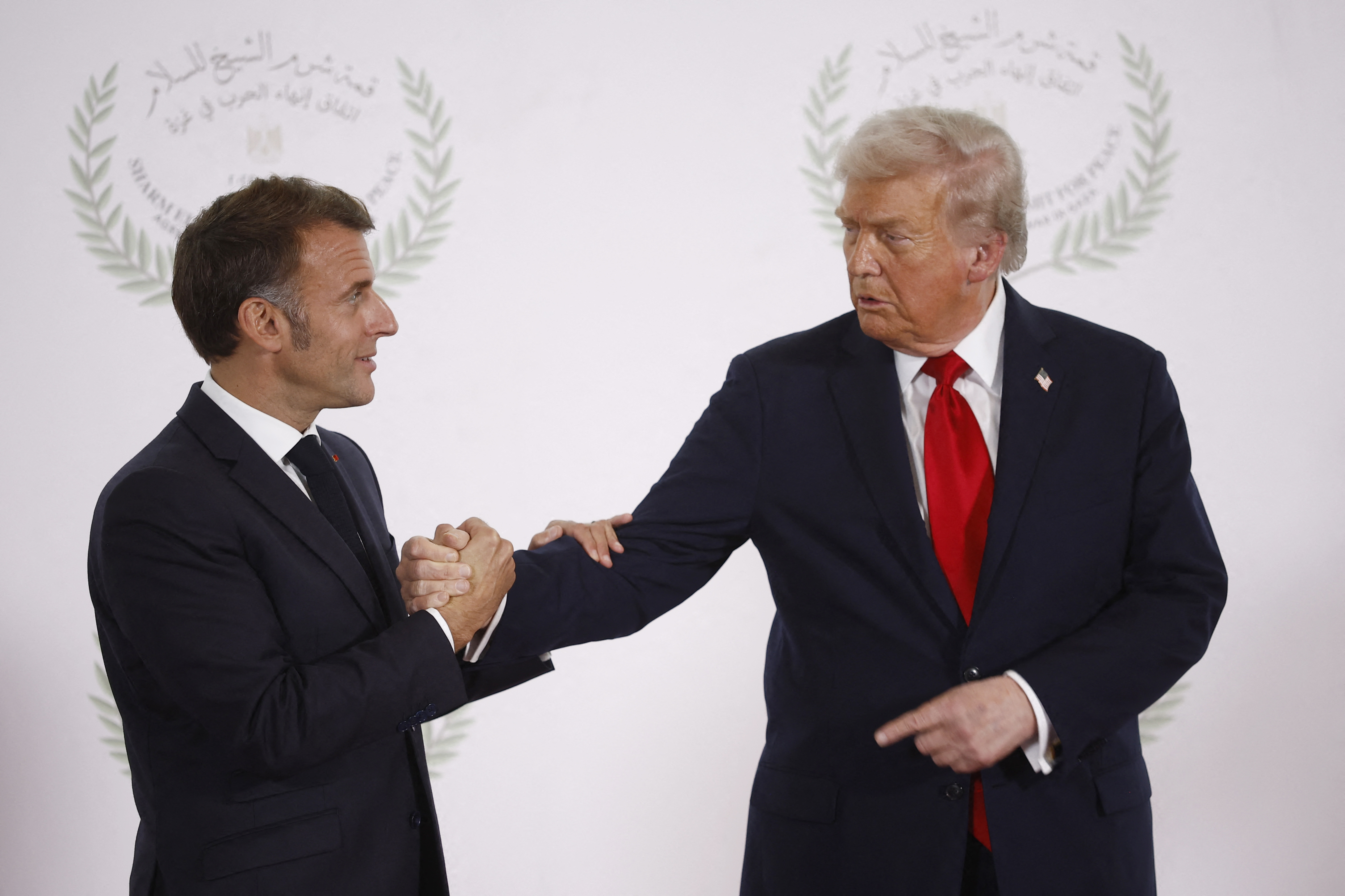 French President Emmanuel Macron and US President Donald Trump shake hands during the greetings ceremony at the Gaza Peace Summit in Sharm El-Sheikh, Egypt on October 13, 2025 | Source: Getty Images