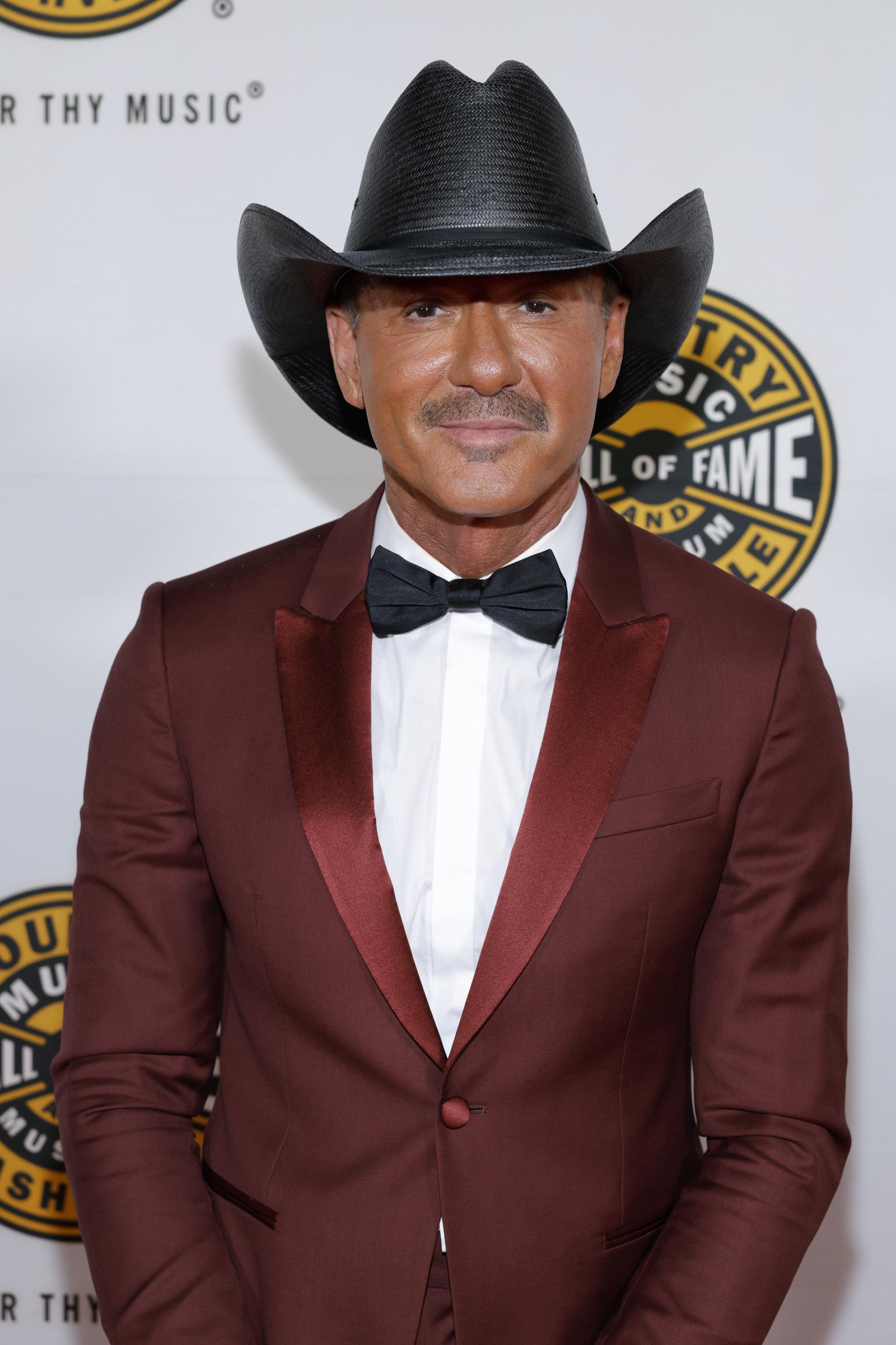 Tim McGraw poses for a close-up portrait in his burgundy suit and black cowboy hat at the Country Music Hall of Fame and Museum’s 2026 Medallion Ceremony in Nashville, Tennessee, on October 18, 2026. | Source: Getty Images