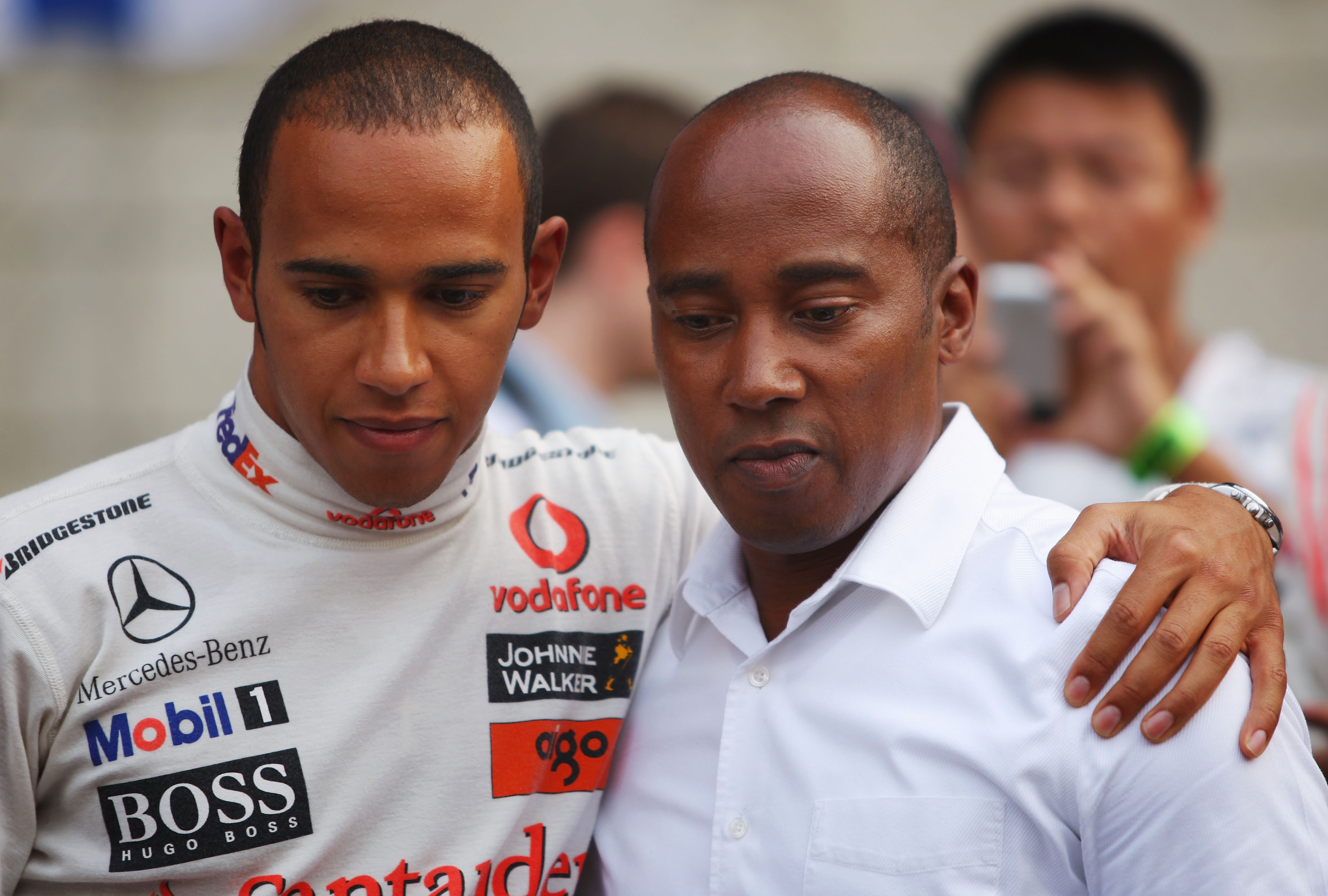 Lewis and Anthony Hamilton are seen on the grid before the start of the Chinese Formula One Grand Prix at the Shanghai International Circuit on October 19, 2008, in Shanghai, China. | Source: Getty Images