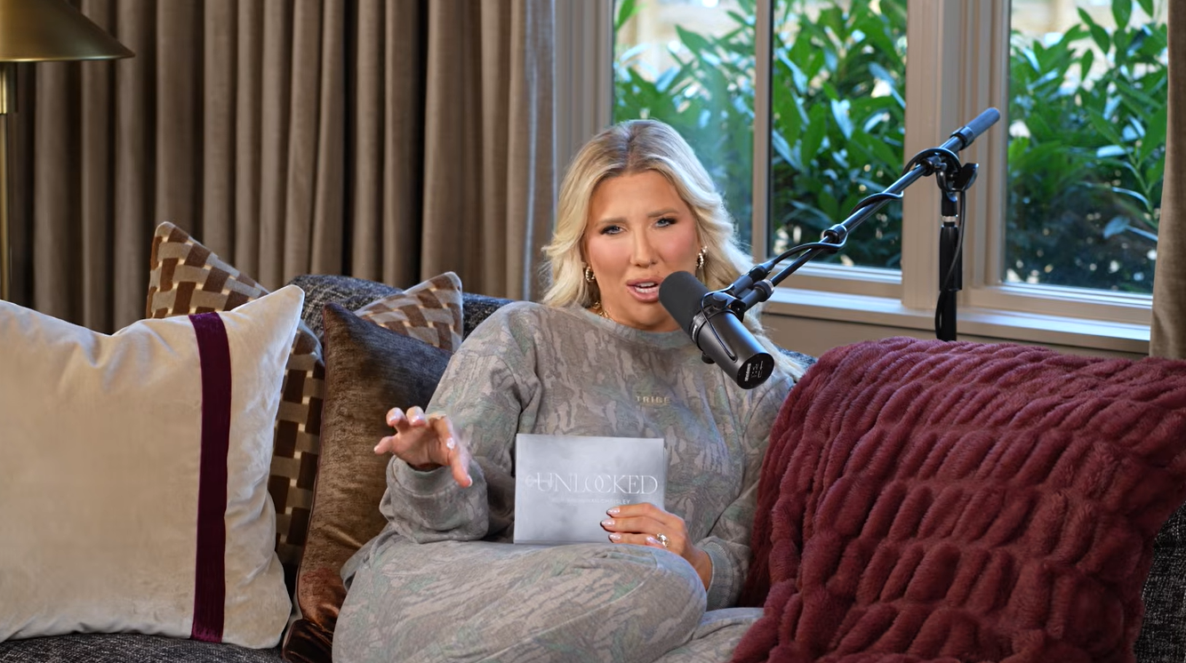 Savannah speaks into a microphone while seated on a couch during an episode of her podcast, Unlocked with Savannah Chrisley. She opened up about her IVF journey, including the emotional challenges of fertility treatments and her struggles with endometriosis. | Source: Youtube/SavannahChrisleyOfficial