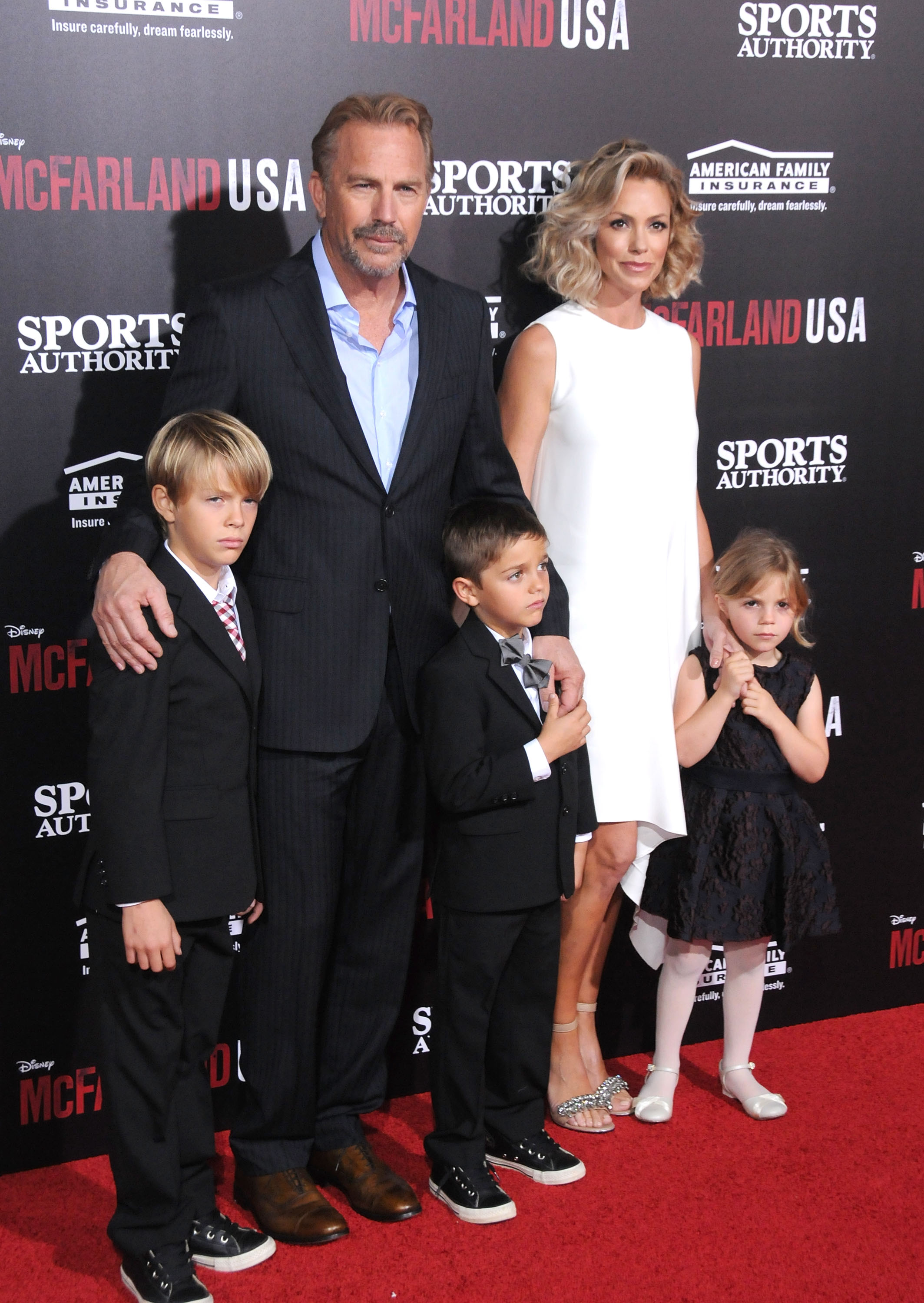Cayden, Kevin, and Hayes Costner with Christine Baumgartner and Grace Costner at the world premiere of "McFarland, USA," in 2015 | Source: Getty Images