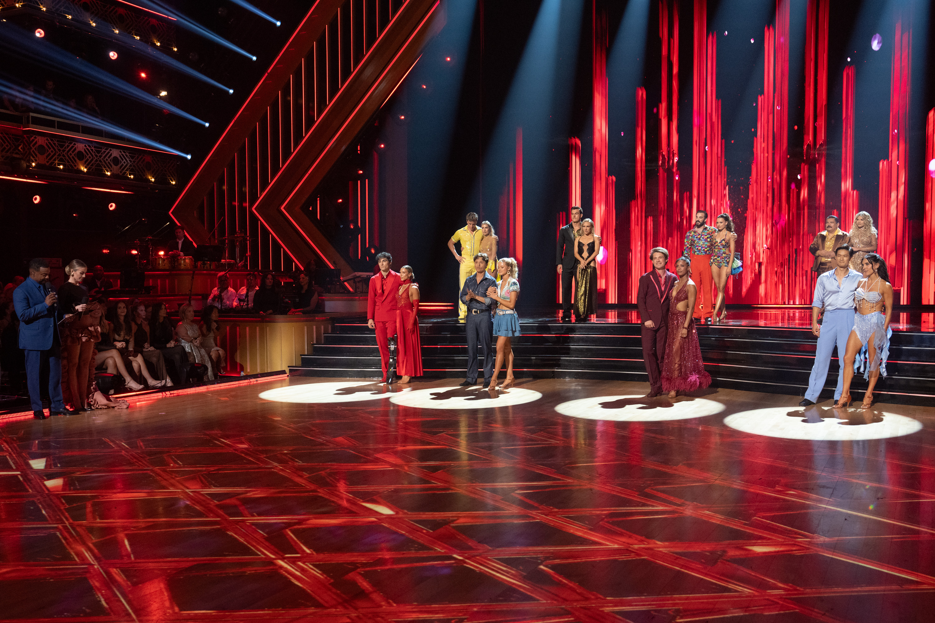 The male celebrity contestants and their professional partners await the Night 1 results. Judges' scores were combined with viewer votes to determine which couples advanced. | Source: Getty Images