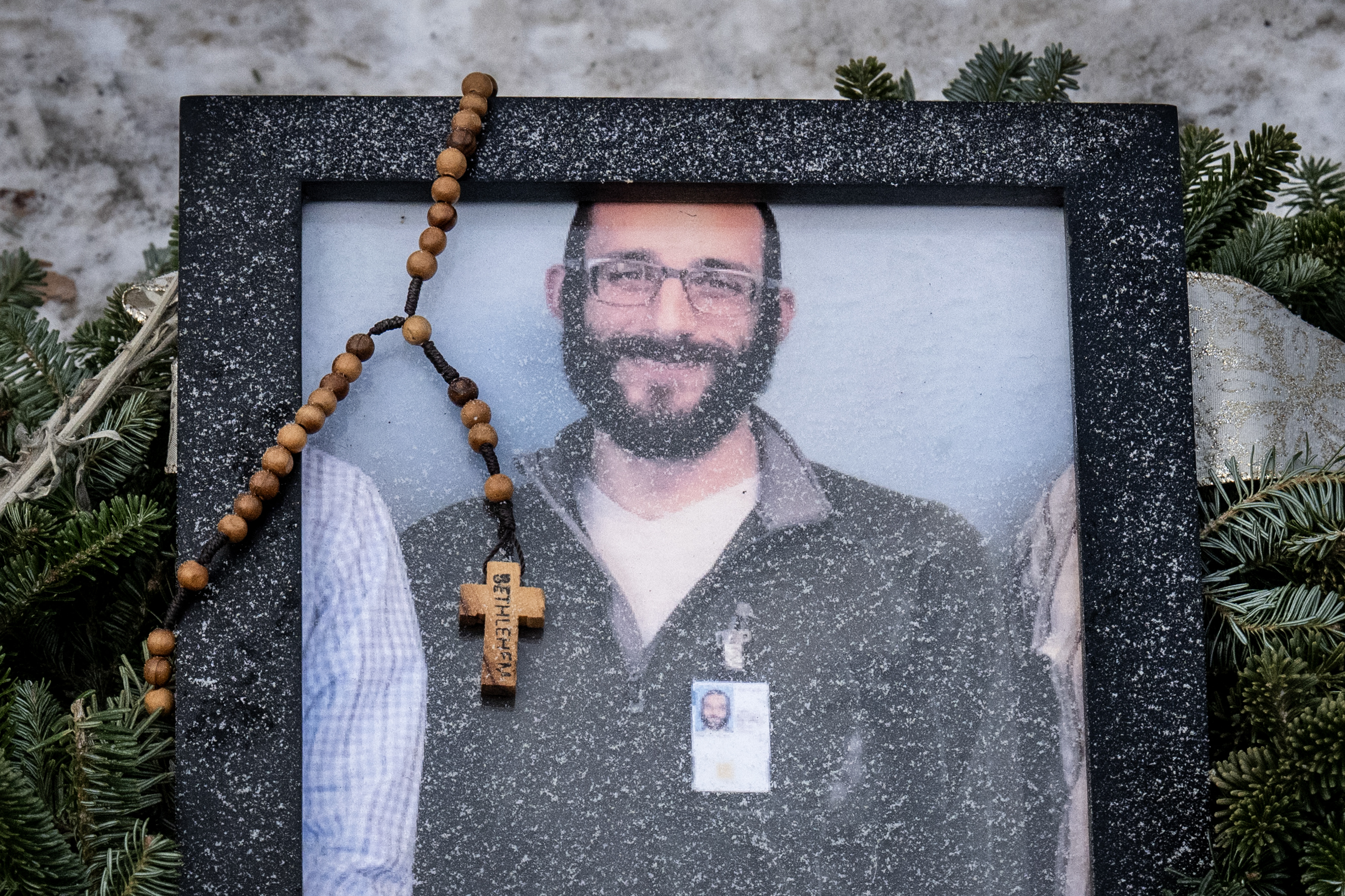 A rosary adorns a framed photo of Alex Pretti at a makeshift memorial in the area where Pretti was shot a day earlier by federal immigration agents on January 25, 2026, in Minneapolis, Minnesota | Source: Getty Images