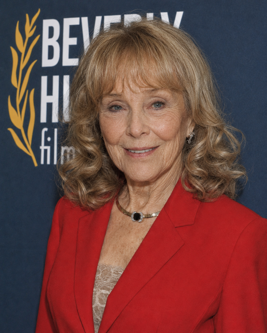 This computer-generated rendering envisions Barbara Eden with fewer facial lines and a fuller complexion while retaining her curly hairstyle and bright red blazer. | Source: ChatGPT