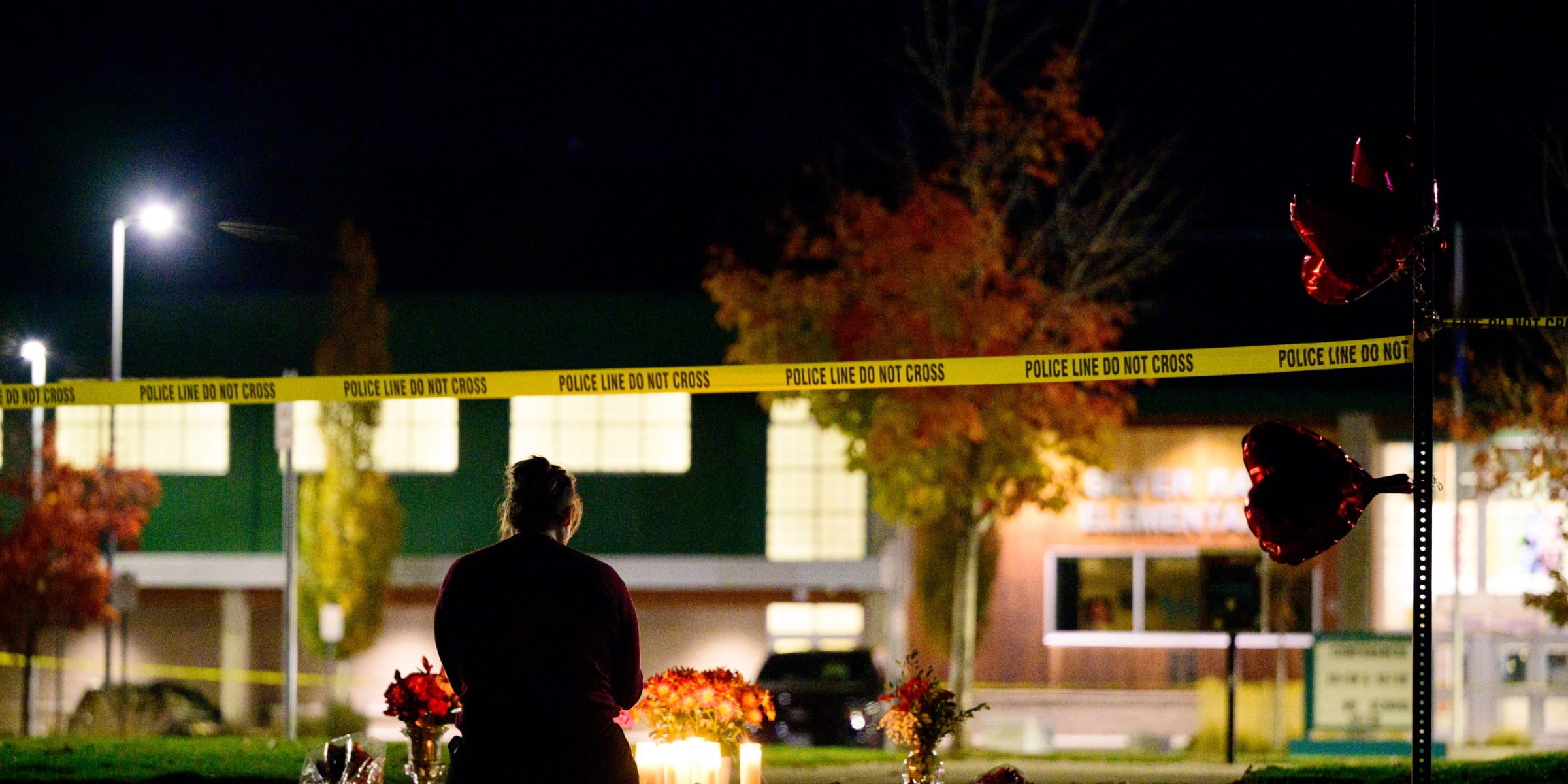 A woman grieves at a candlelight memorial out front of Silver Rail Elementary School on October 15, 2026 in Bend, Oregon. | Source: Getty Images