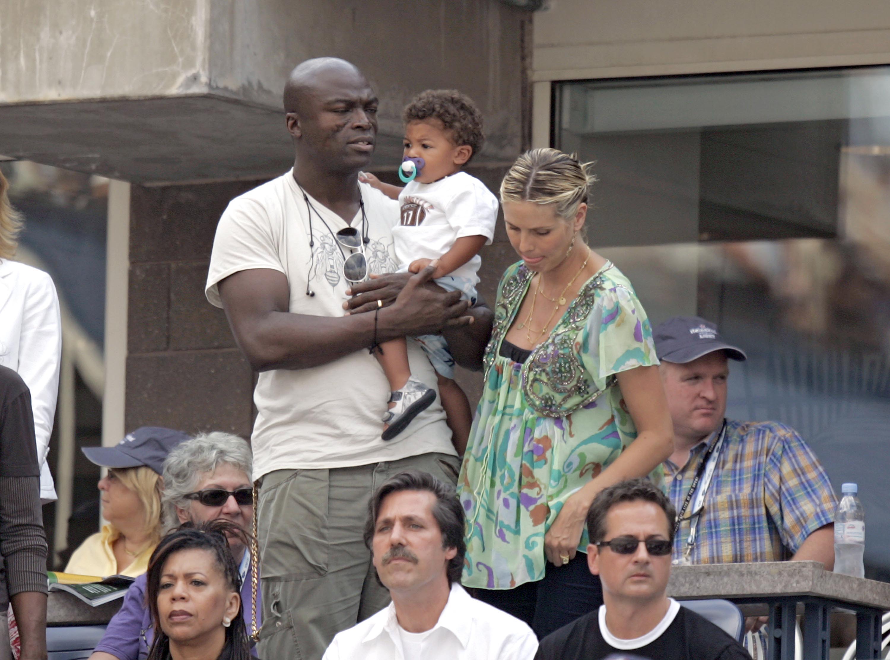 Heidi Klum and Seal were spotted out with their young son, Henry, sharing a sweet family moment. Seal kept it casual in a beige graphic tee and cargo pants as he carried Henry. Heidi looked effortlessly stylish in a flowy green blouse, slicked-back hair, and layered necklaces.