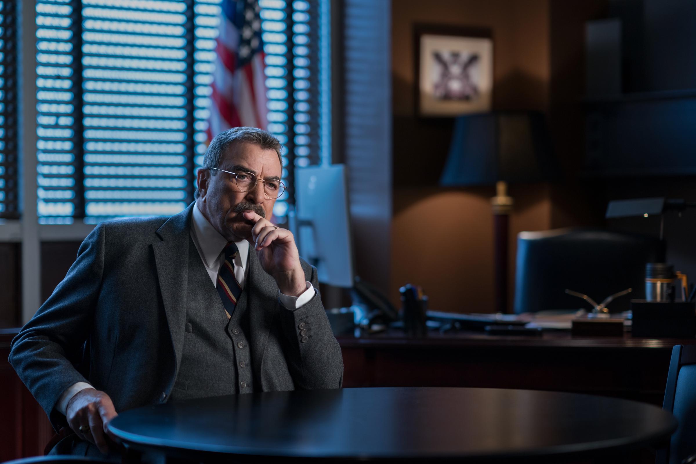 Tom Selleck sits in his office in the historic series finale episode of "BLUE BLOODS," in New York City on December 13, 2024 | Source: Getty Images