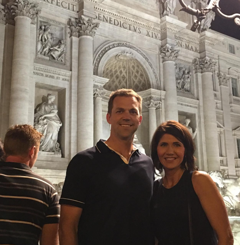 Framed by grand architecture, Kristi and Bryon stand side by side—travel-worn but smiling, capturing a moment that feels both personal and quietly historic. | Source: Instagram/sdbryonnoem