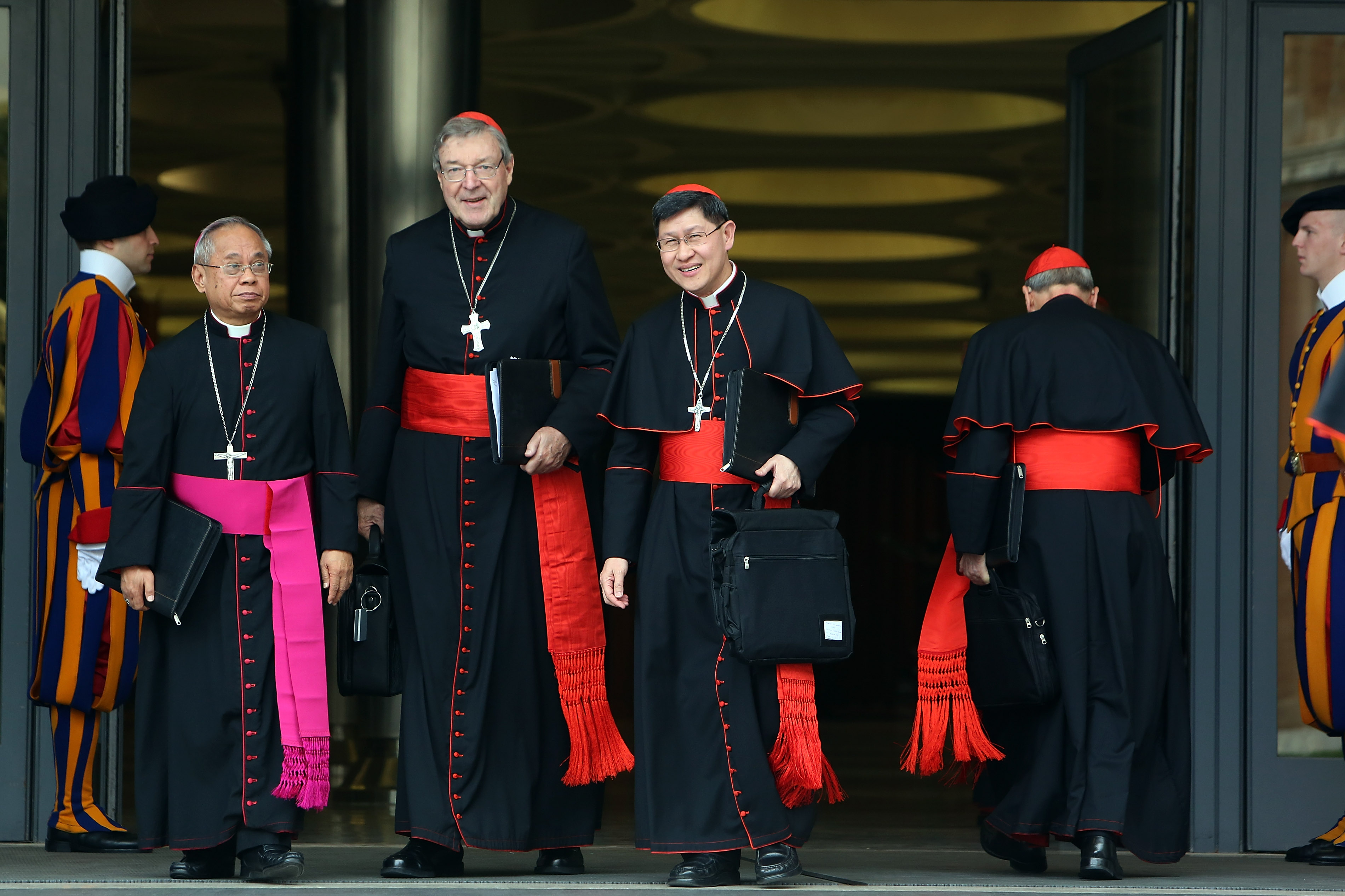 Archbishop of Sydney Cardinal George Pell (2nd L) and Archbishop of Manila, Cardinal Luis Antonio Tagle (2nd R) leave the Paul VI Hall after an Extraordinary Consistory on the themes of Family on February 20, 2014, in Vatican City | Source: Getty Images