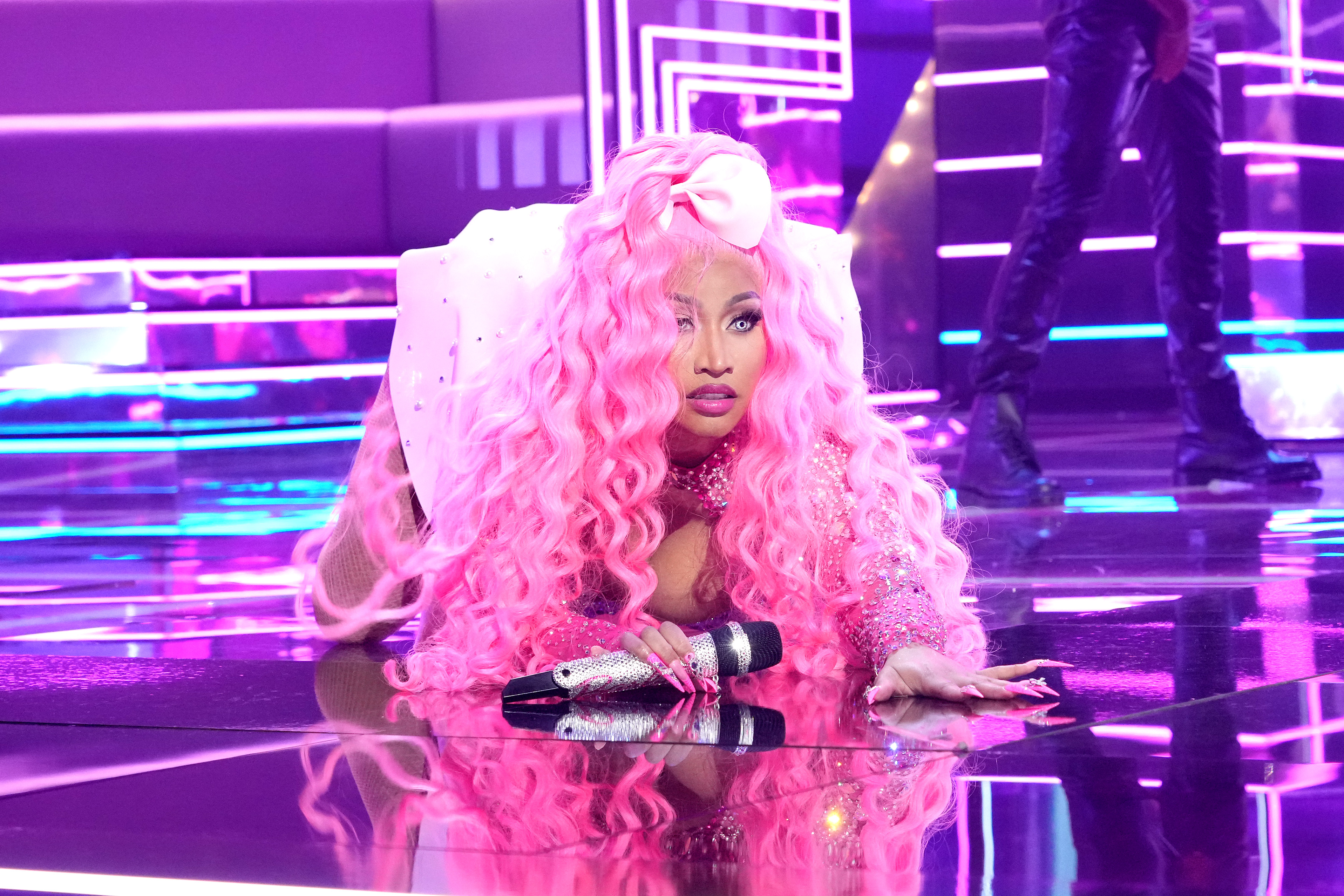 Nicki Minaj performs in Newark, dazzling in a vibrant pink ensemble and cascading curls as she deliveres a high-energy performance for the audience.