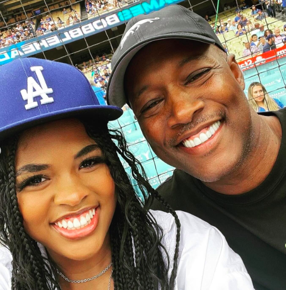Flex Alexander smiling widely for a photo with his and Shanice's daughter. | Source: Instagram/flexaforeal