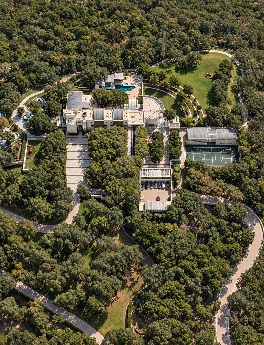 The Dells’ secluded “Castle” features a private basketball court, winding driveways, and dense woodland shielding the estate from outsiders. | Source: Apple Maps