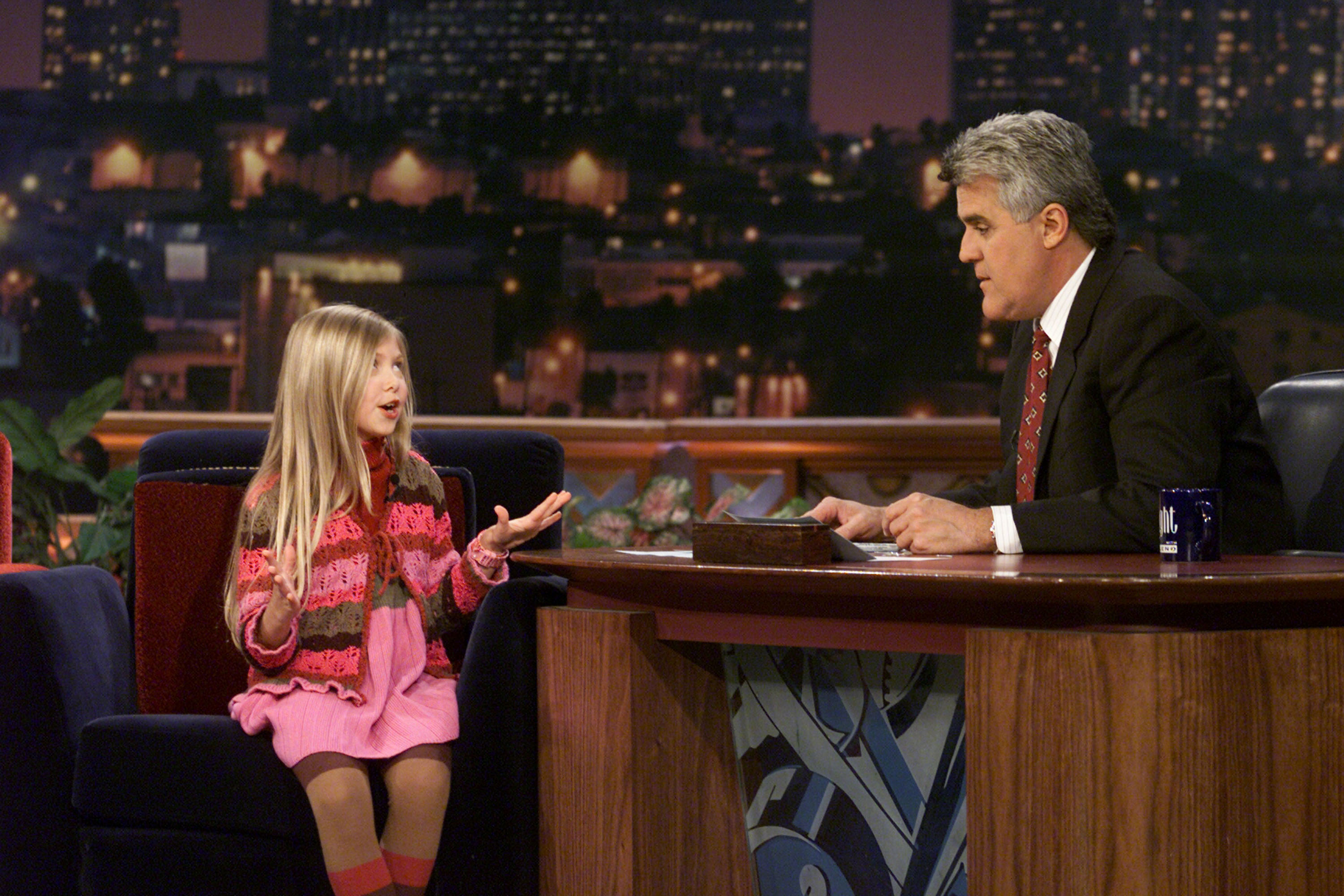 Taylor Momsen exudes sass and confidence during her interview with host Jay Leno, seated like a pro in a brightly colored outfit that matched her bold energy.
