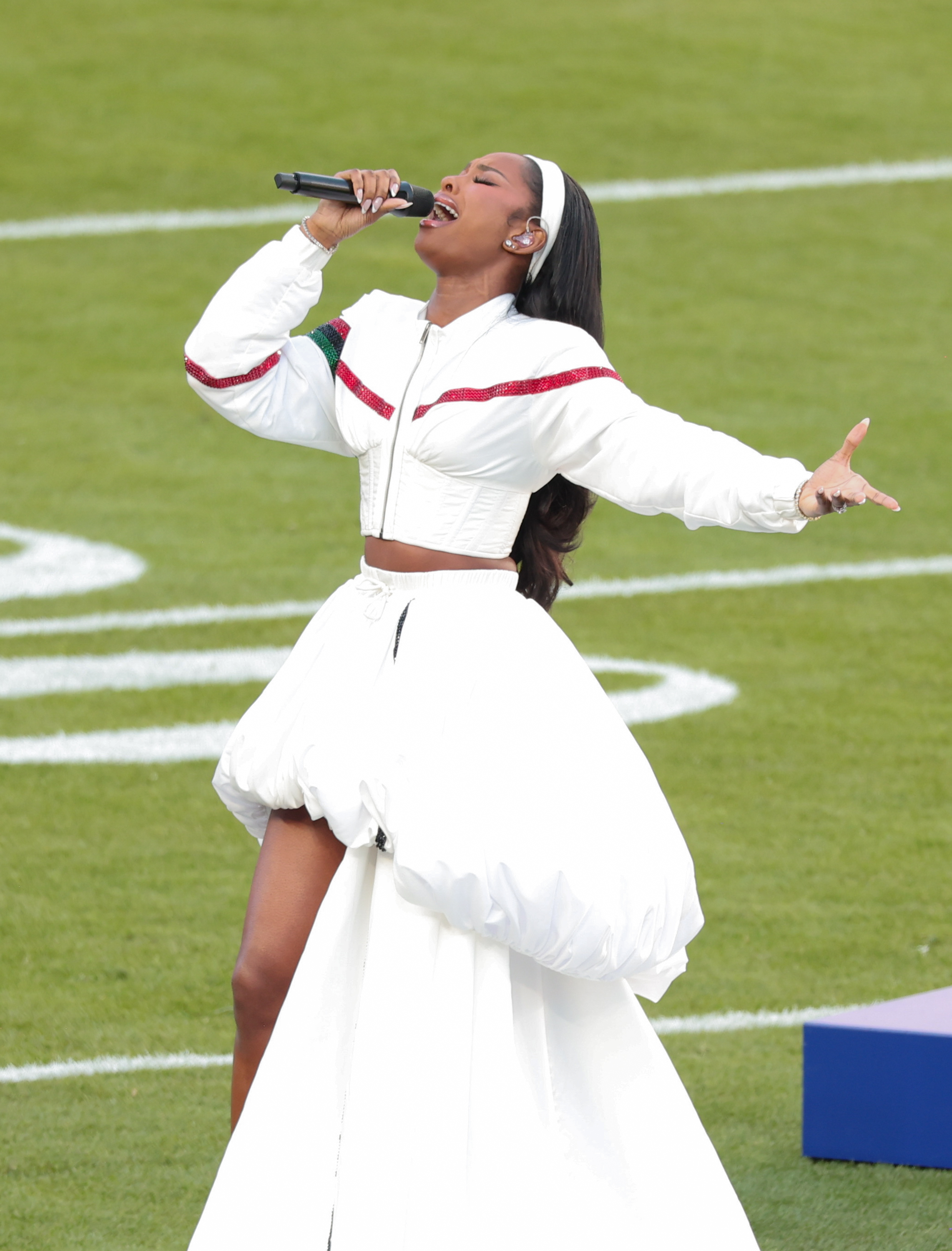 Coco Jones belting out a note as she sings "Lift Every Voice and Sing." | Source: Getty Images