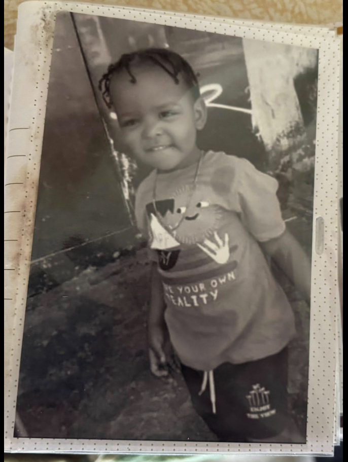 A smiling black-and-white photo shows Tadens Joseph posing in a T-shirt and shorts. | Source: Facebook/Eric Graves﻿