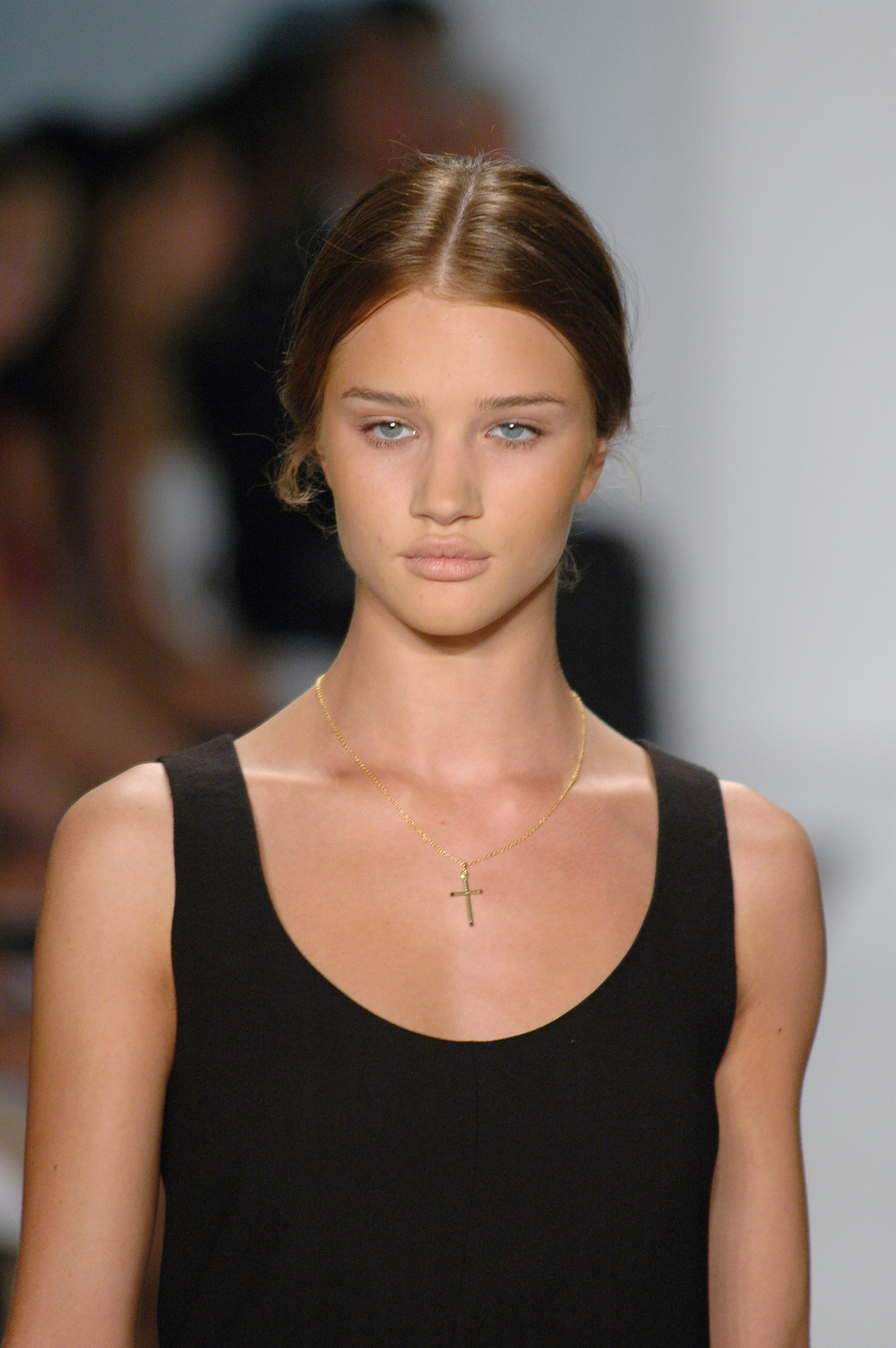 Rosie Huntington-Whiteley keeps it effortlessly chic in a minimalist black dress and delicate cross necklace. | Source: Getty Images