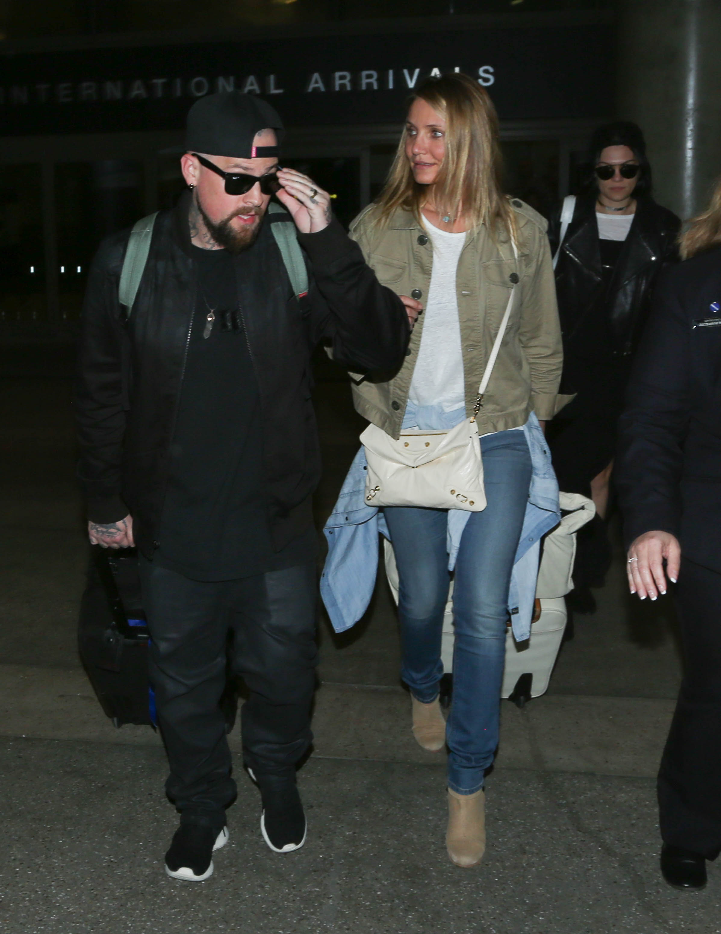 Fresh from their travels, Cameron Diaz and Benji Madden were photographed at Los Angeles International Airport on August 31, walking through the International Arrivals terminal. The actress kept it casual in jeans and a khaki jacket, while her husband led the way in dark streetwear and sunglasses. Fellow star Jessie J trailed just behind the couple.