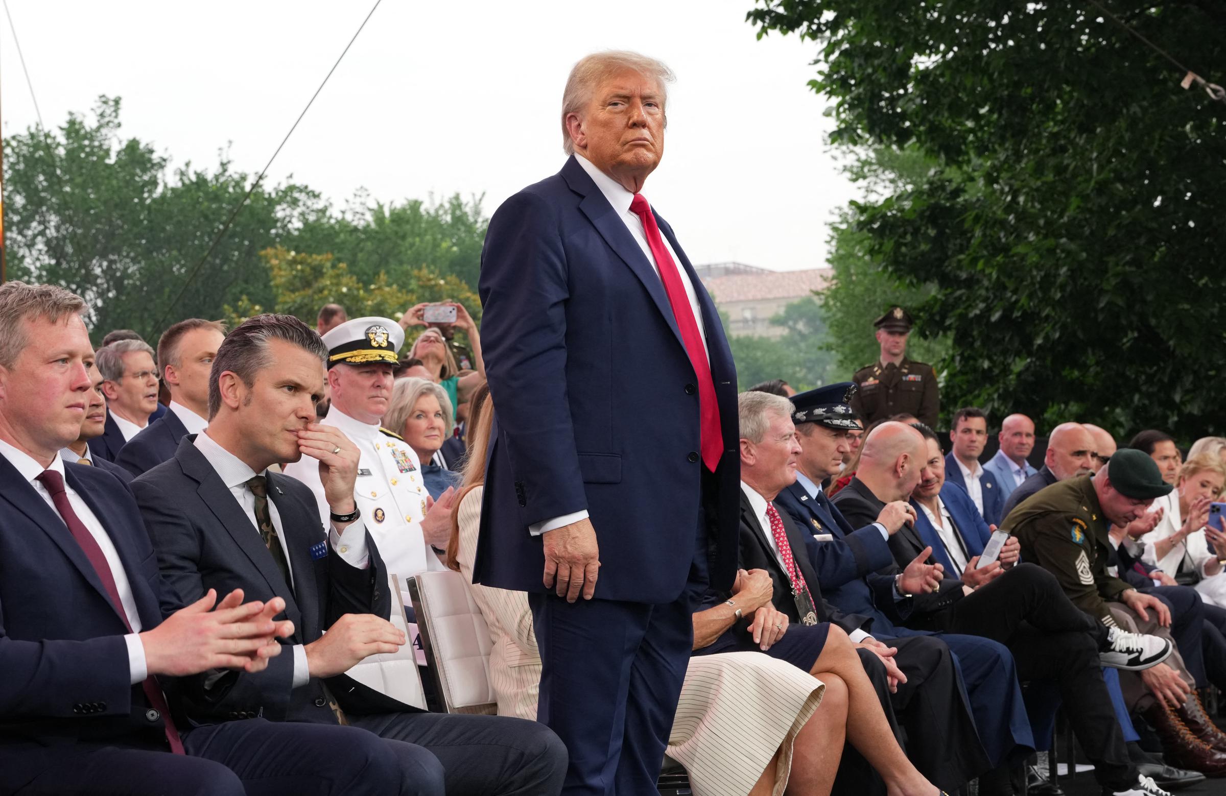 Donald Trump along with others gather on stage to watch the Army 250th Anniversary Parade on June 14, 2025 | Source: Getty Images