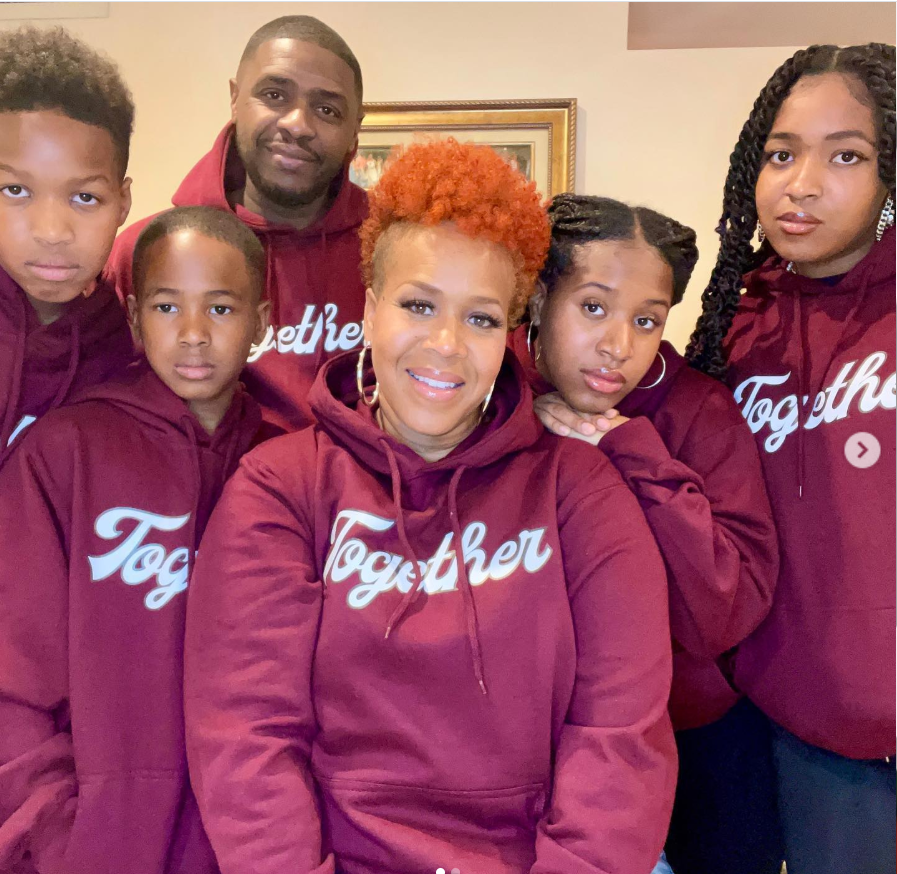 Tina Campbell and Teddy Campbell posing with their children in matching “Together” hoodies during a family portrait. | Source: Instagram/teddyandtina