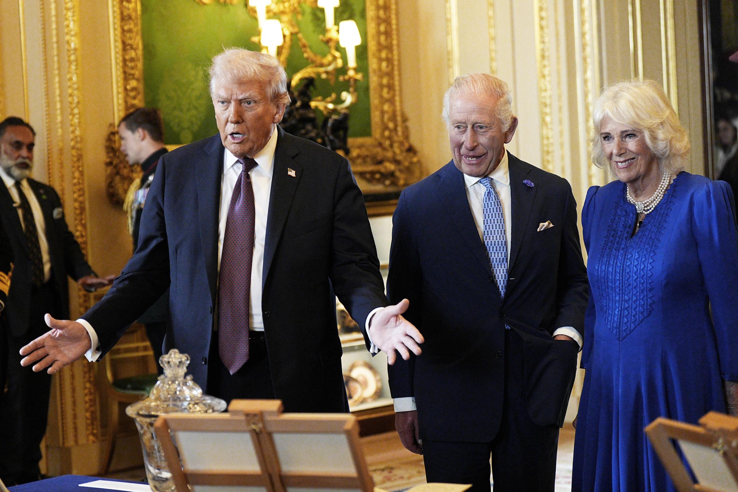 President Donald Trump with King Charles III and Queen Camilla viewing items on display during a visit to the Royal Collection exhibition at Windsor Castle on September 17, 2025, in England. | Source: Getty Images