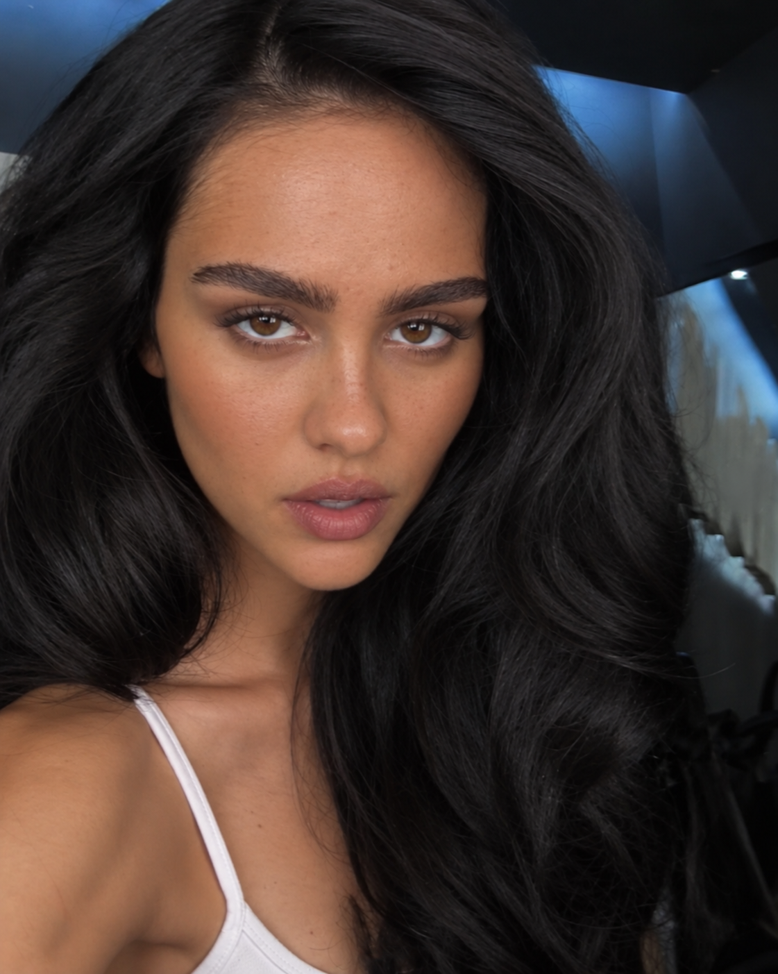 AI imagines Amelia Gray Hamlin with flowing dark hair, prominent brows, softly shaped lips, and freckles visible across her face. | Source: ChatGPT