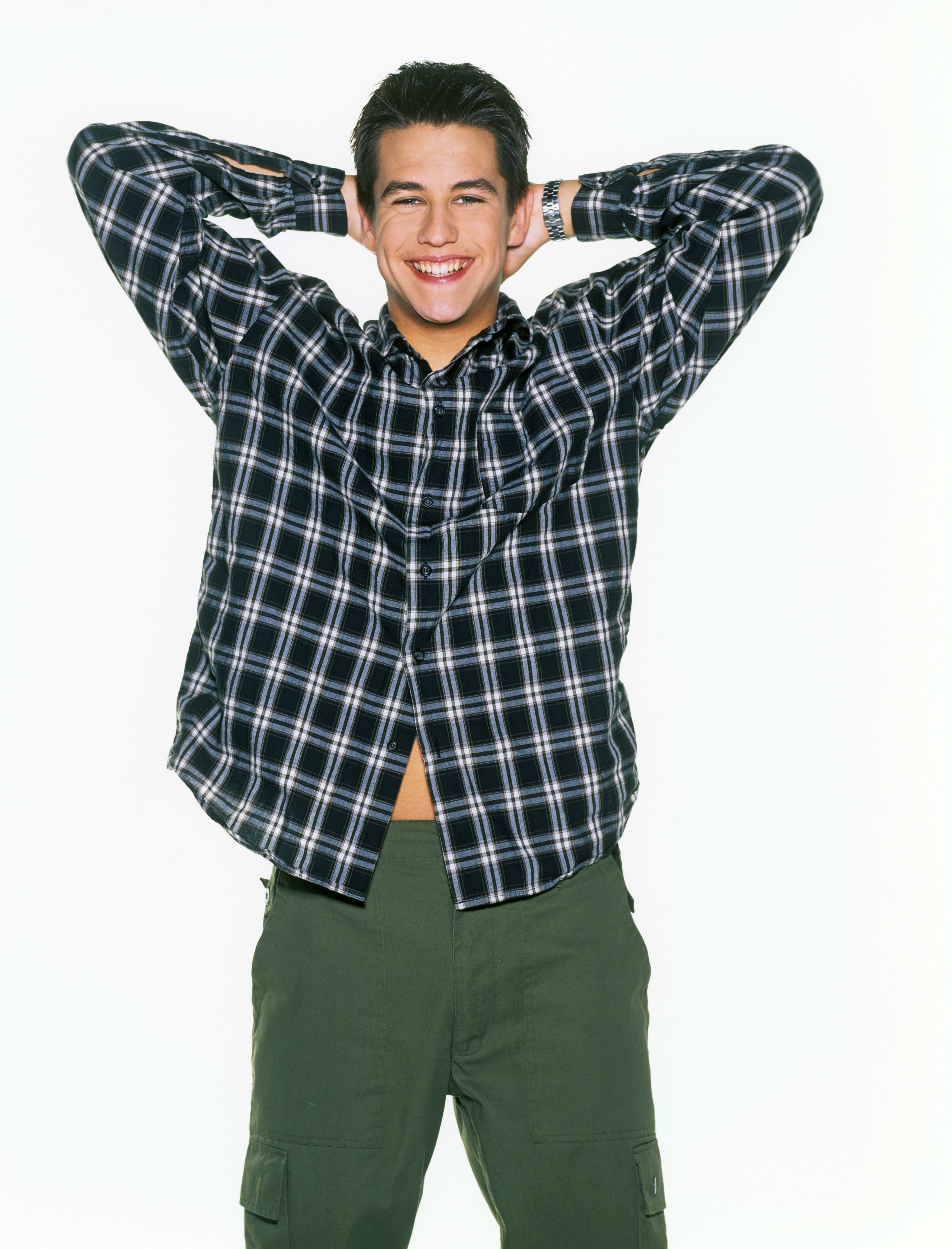 The singer in Munich at 18, beaming with youthful joy as he strikes a playful pose in a laid-back outfit. This is a glimpse of carefree confidence at the start of his journey.