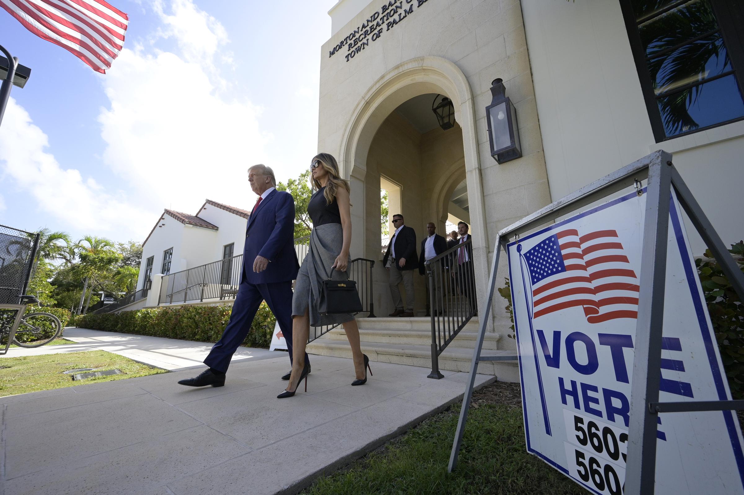Former First Lady Melania Trump leaves the polling precinct after voting in the midterm elections in Palm Beach, Florida, on November 8, 2022, wearing a sleeveless Alexander McQueen knit dress with a draped houndstooth skirt, anchored by black patent leather Christian Louboutin "So Kate" pointed-toe stiletto pumps.