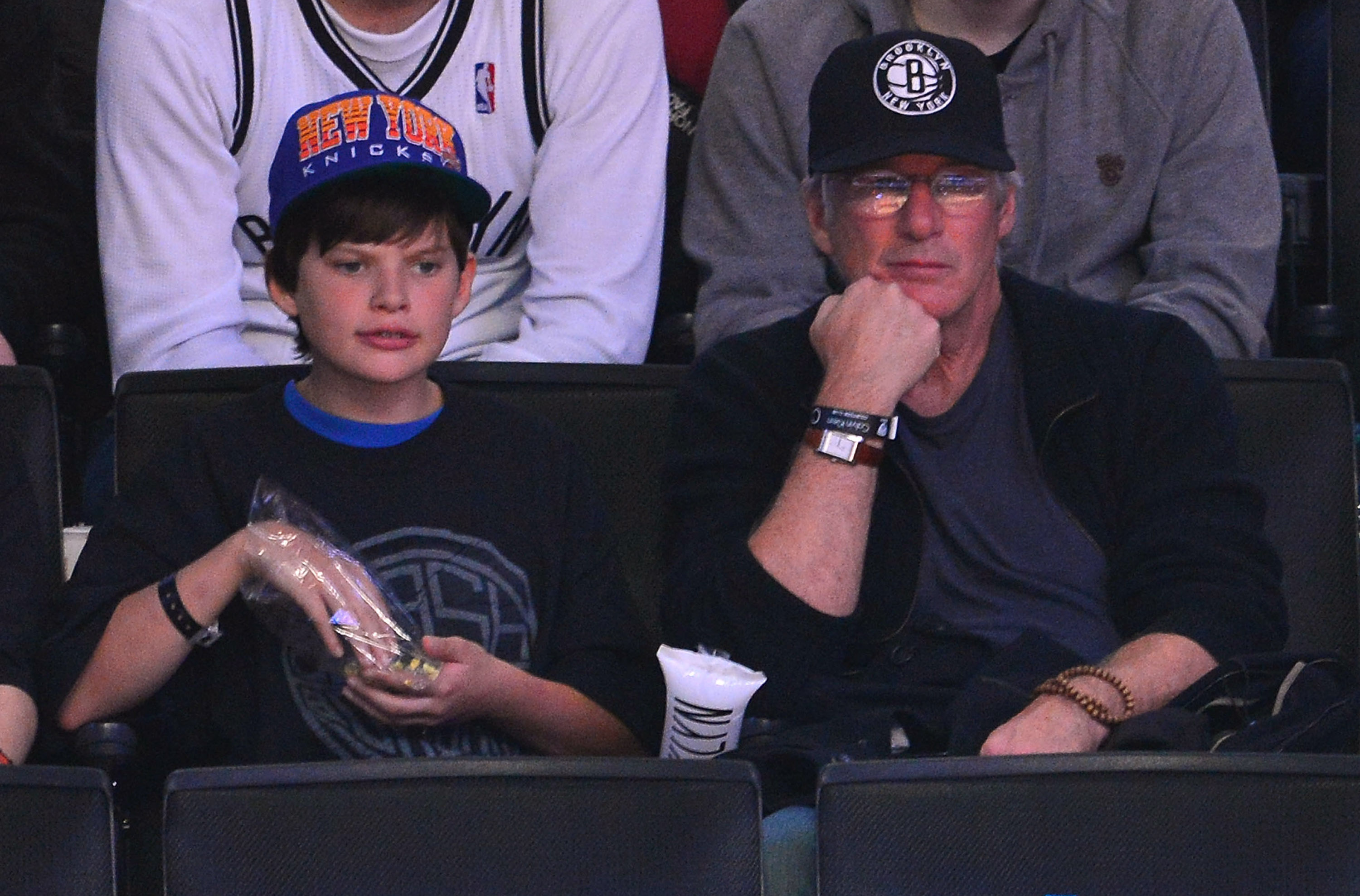 Richard Gere and his son, Homer James Jigme Gere, attend the New York Knicks vs. Brooklyn Nets game at Barclays Center in Brooklyn, New York.