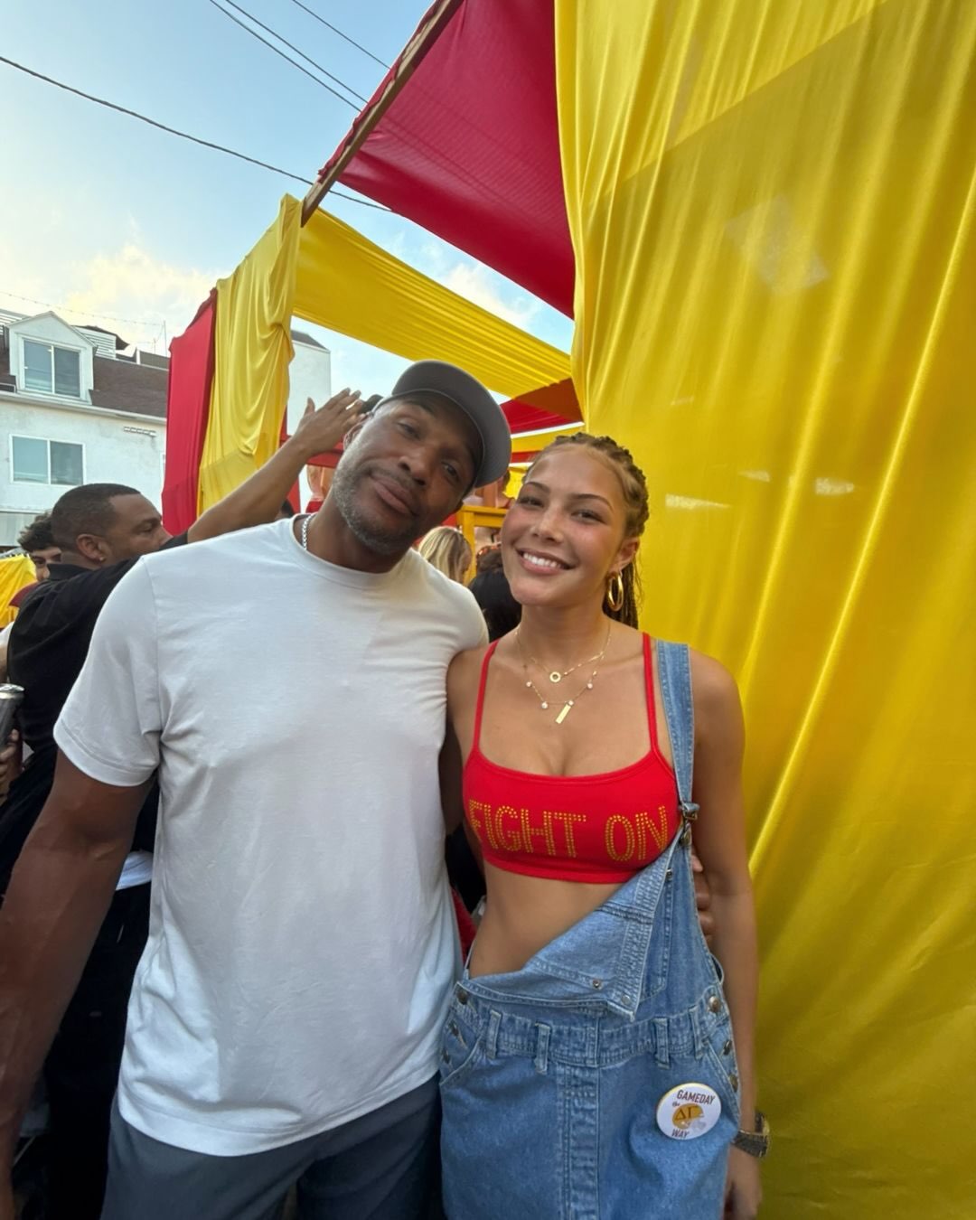 Michael Strahan poses with one of his daughters at a colorful outdoor event, adding another cherished father-daughter memory to the birthday carousel. | Source: Instagram/michaelstrahan