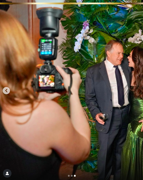 A photographer taking a picture of Bill Belichick and Jordon Hudson during a celebration, posted on April 16, 2025. | Source: Instagram/jordon
