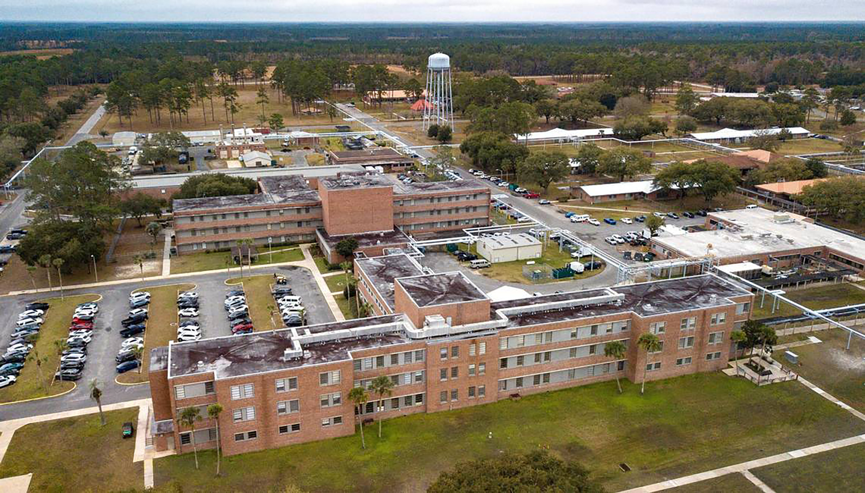 Beyond the entrance, an aerial view reveals the sprawling Northeast Florida State Hospital campus where Yarbrough's sister, Evelyn Motel, and mother, Minnie Yarbrough, visited him weekly. They would walk the grounds together, but Motel recalled that her brother could not reliably find his way back to his room on his own.