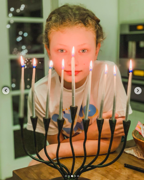 Billie Dane posing behind a Hanukkah candle. | Source: Instagram/rebeccagayheartdane