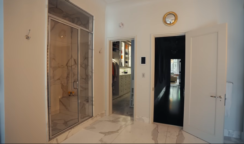 The bathroom flows directly toward the closet, making the primary suite feel like a private apartment. This is where viewers really began joking about the scale of the home. | Source: YouTube/Architectural Digest