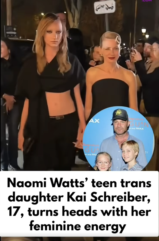 Kai Schreiber walks beside Naomi Watts in Paris. Her cropped black top and low-rise trousers create a bold, runway-inspired look. The pair pass through a crowd of photographers outside the venue. | Source: Facebook/IWMBuzz