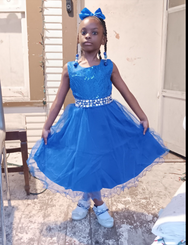 A portrait of one of Shamar Elkins’s children shows her standing poised in a bright blue dress, holding the skirt out slightly as if mid-twirl. | Source: Facebook/Shaneiqua Elkins