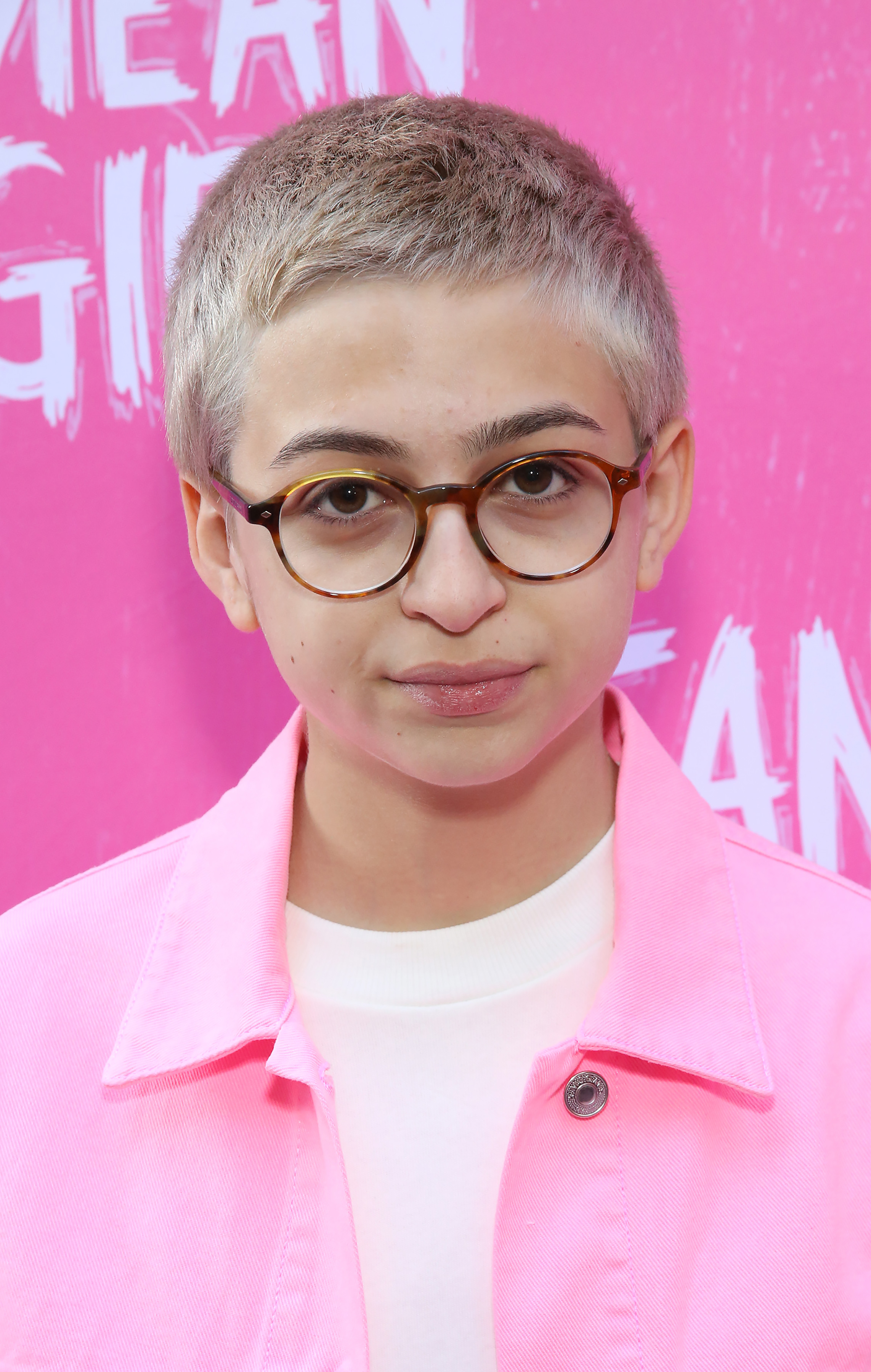 J.J. Totah attends the Broadway opening-night performance of Mean Girls at the August Wilson Theatre in New York City, wearing a bright pink jacket over a white shirt and round glasses. | Source: Getty Images