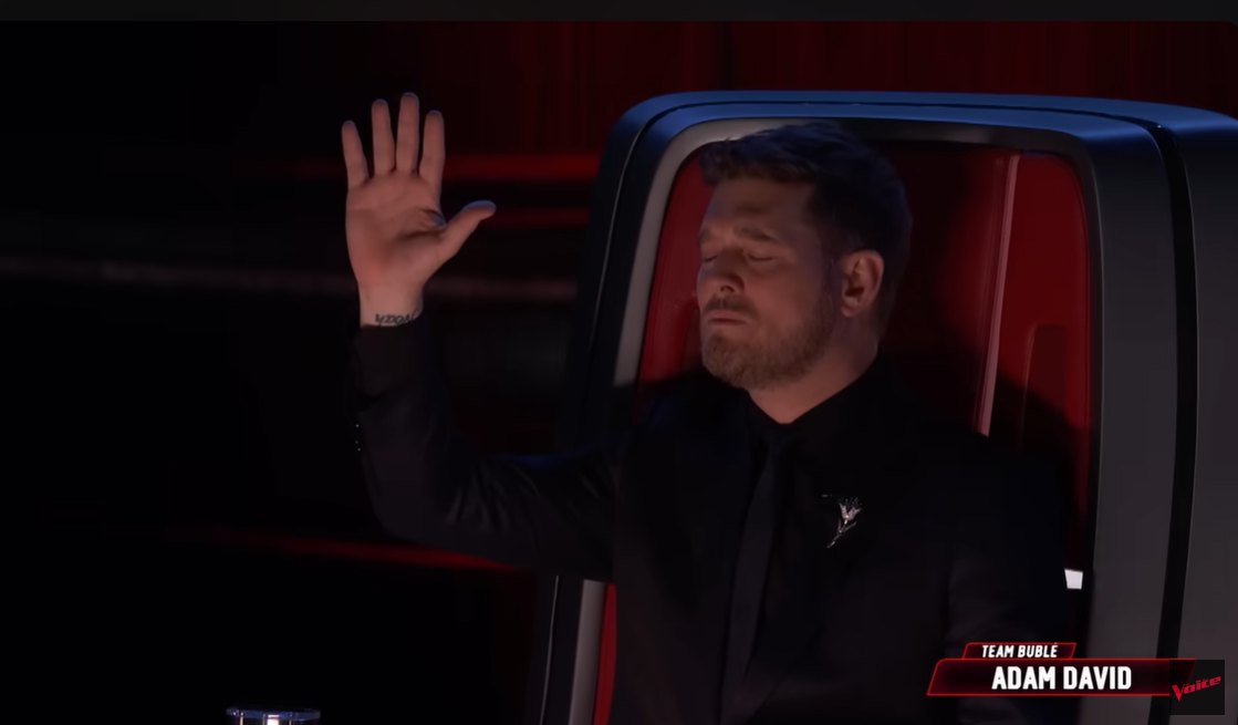 Coach Michael Bublé reacts with eyes closed and hand raised while listening to Adam David's finale performance | Source: YouTube/nbcthevoice