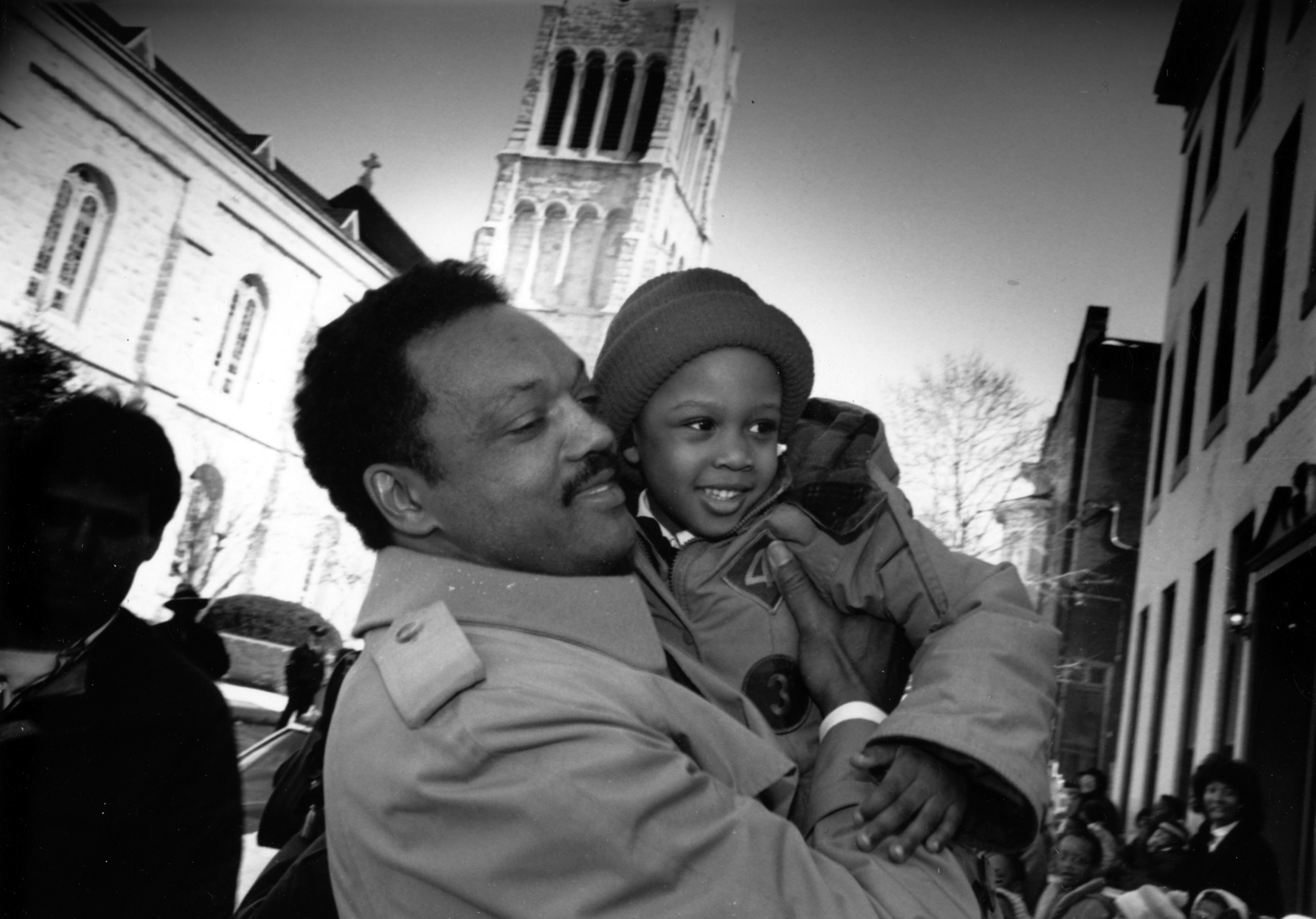Jesse Jackson Sr. holds a boy at a rally in front of a church in 1965 | Source: Getty Images