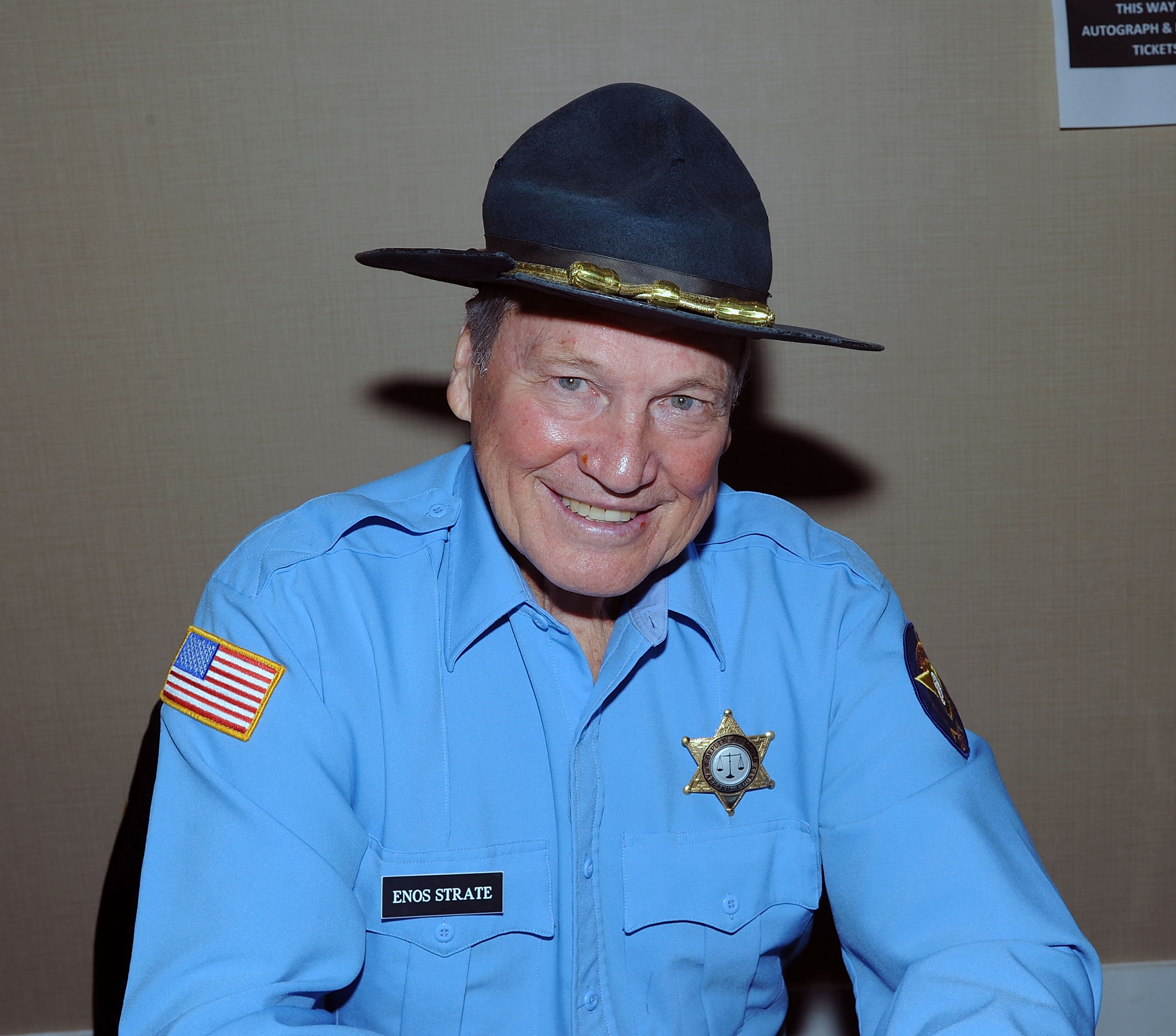 Decades after "The Dukes of Hazzard," Shroyer was still appearing at fan events in full Enos Strate costume. This 2016 convention photo shows how closely the character remained tied to his public image.  | Source: Getty Images