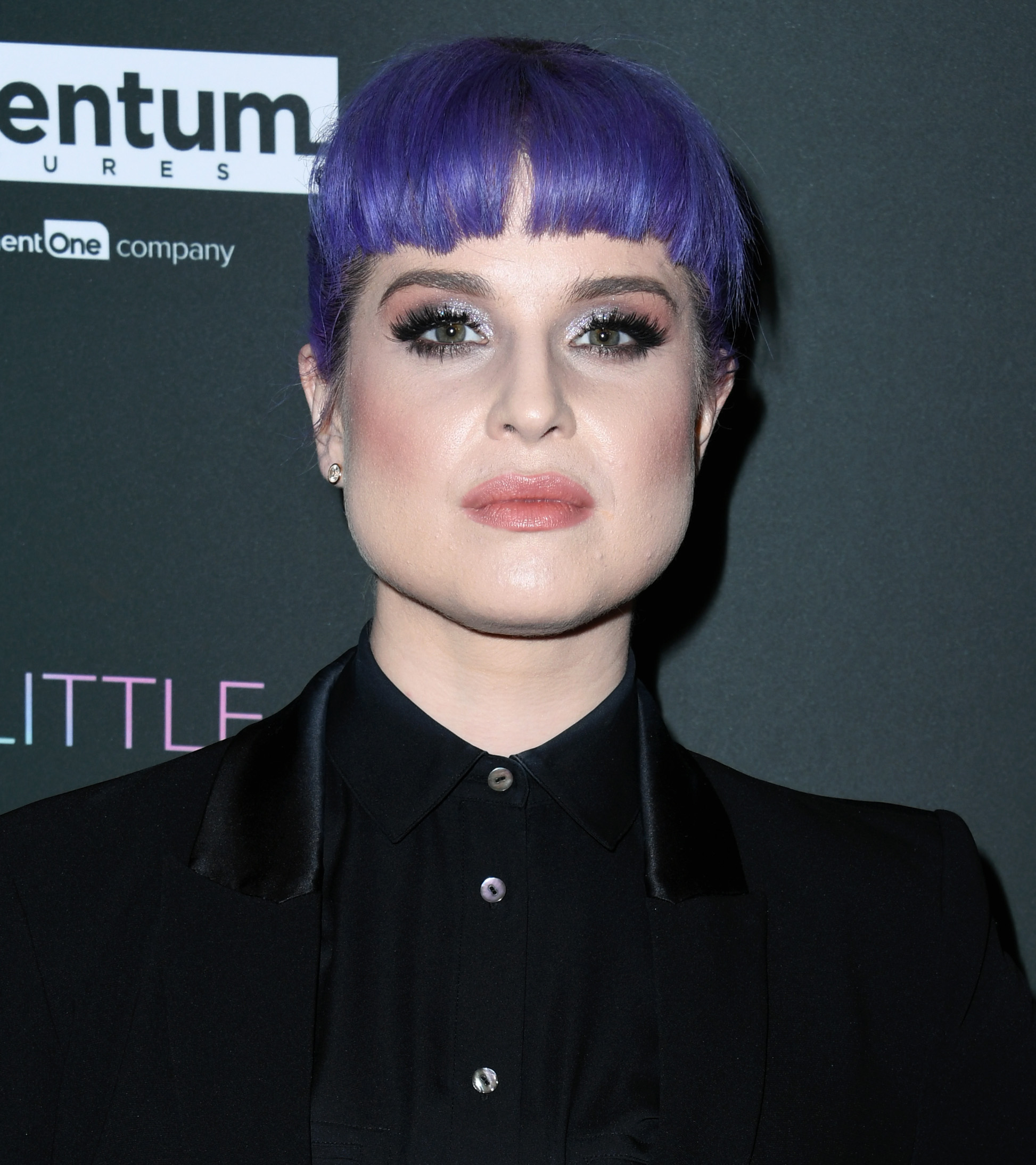 Kelly Osbourne attends a special screening of "A Million Little Pieces" in 2019, wearing a tailored black suit and her signature violet hairstyle with blunt bangs. | Source: Getty Images