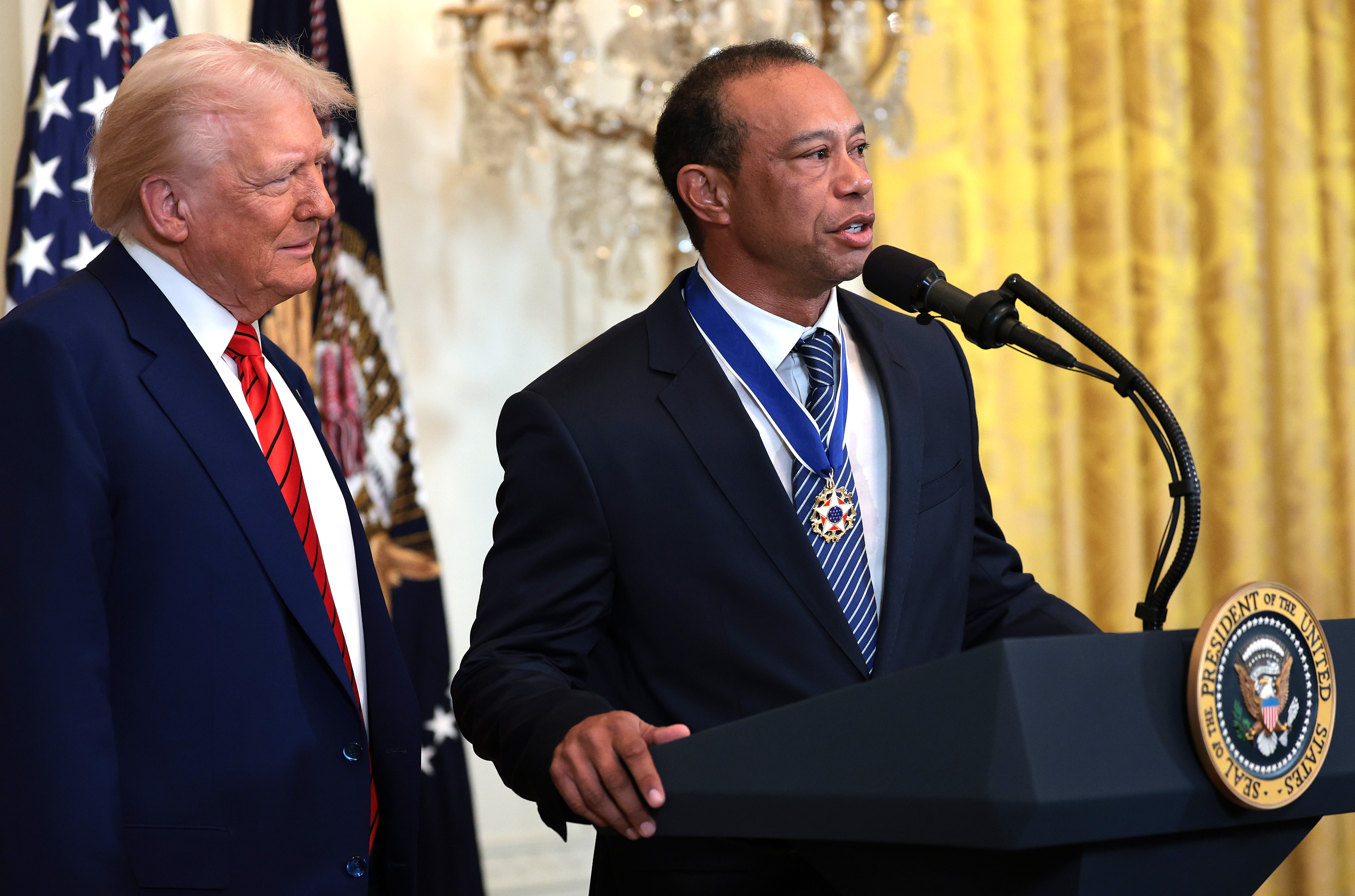 Tiger Woods speaks alongside President Donald Trump during a Black History Month reception in the East Room of the White House in Washington, D.C., on February 20, 2025.