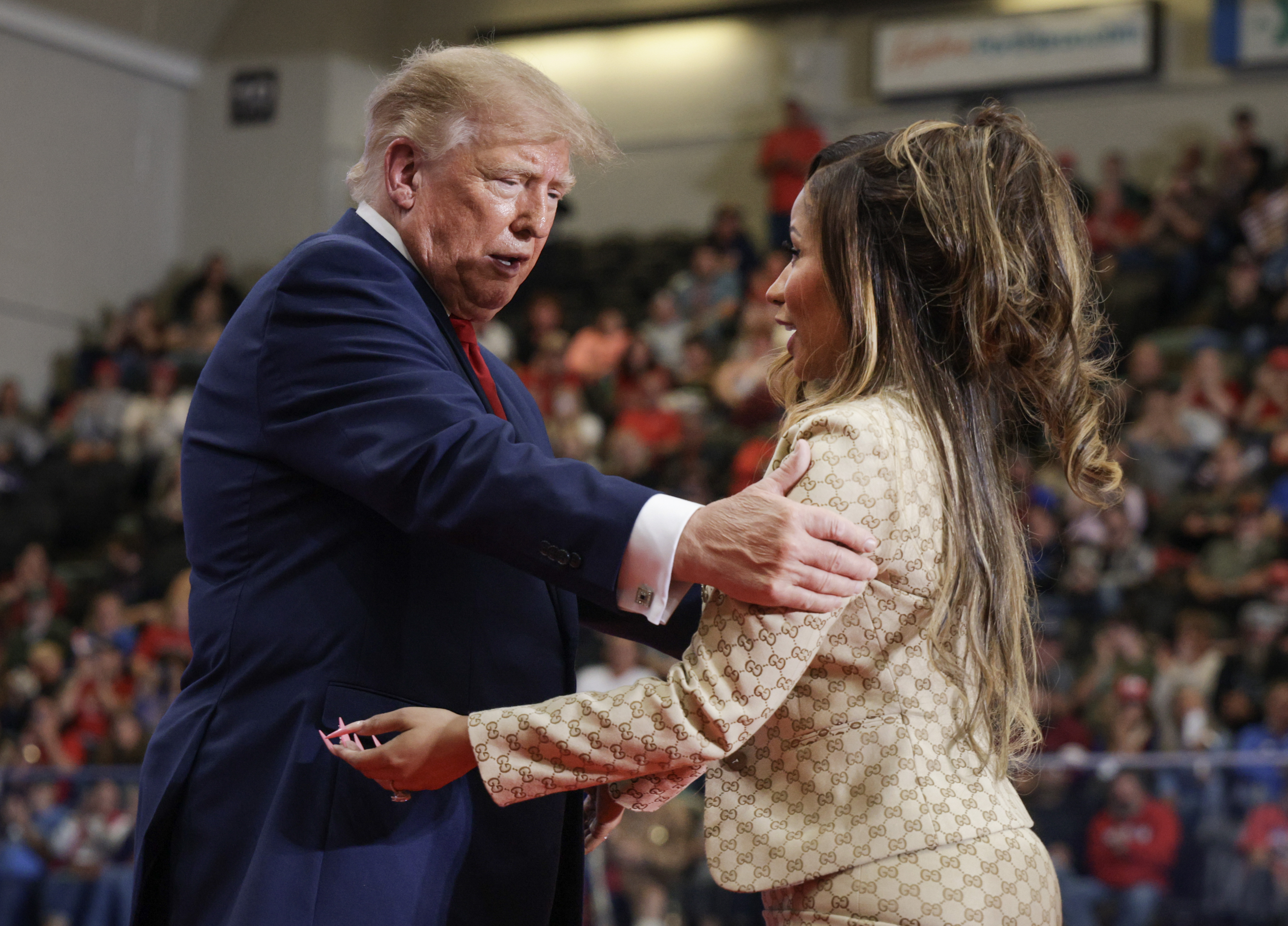 Donald Trump places his hand on Nicki Minaj's upper arm as they exchange words face-to-face onstage — a moment of physical closeness that added to the online discussion about their body language. | Source: Getty Images