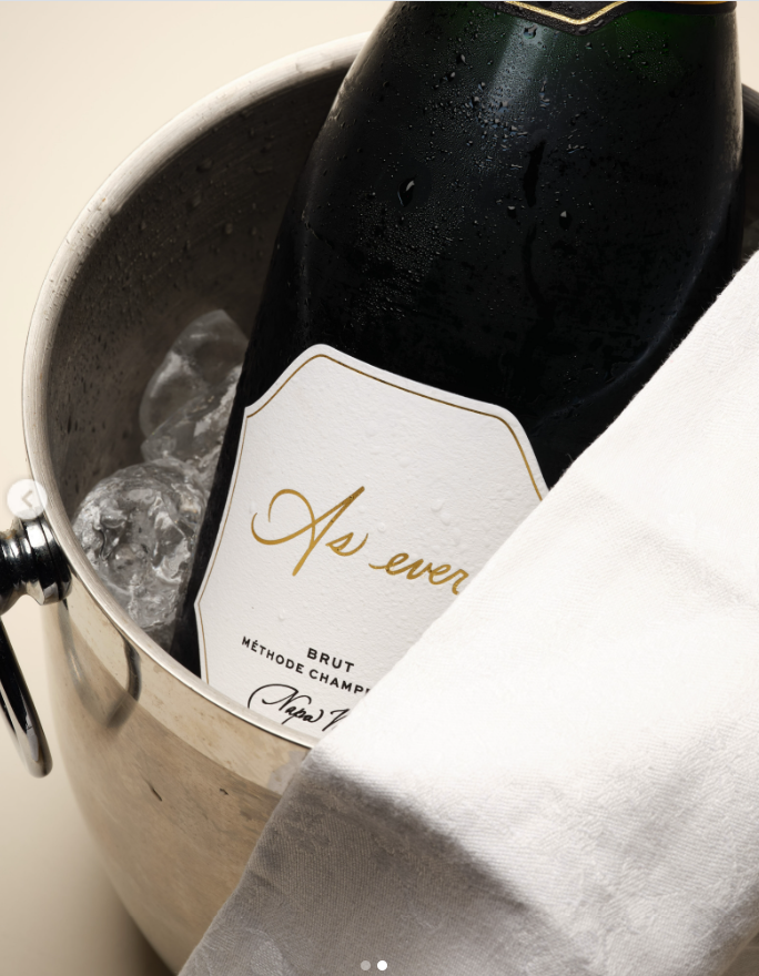 As Ever Reserve Brut sparkling wine is pictured chilling in an ice bucket, featuring the lifestyle brand's signature label and Napa Valley designation. | Source: Instagram/aseverofficial